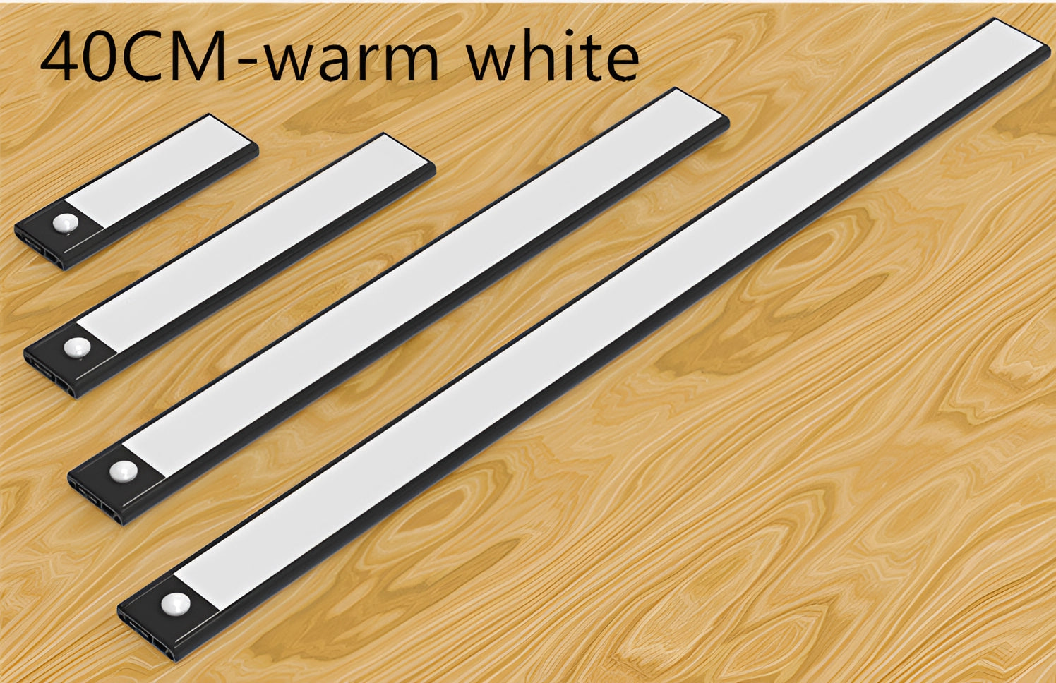Magnetic warm white LED strip lighting installed under a modern kitchen cabinet with a sleek black finish, casting a soft, warm glow over a wooden countertop.