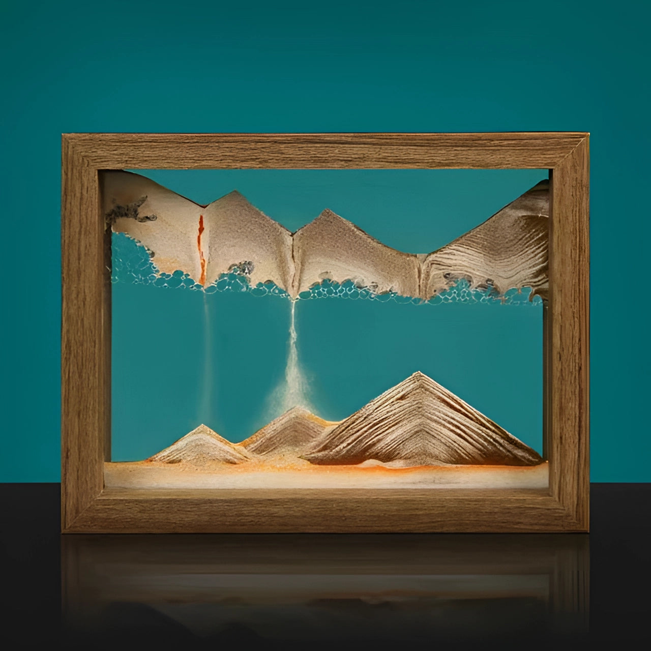 A rectangular 3D kinetic sand art picture frame with an aqua blue design, featuring a wooden border and an artistic landscape pattern in varying shades of orange and brown.
