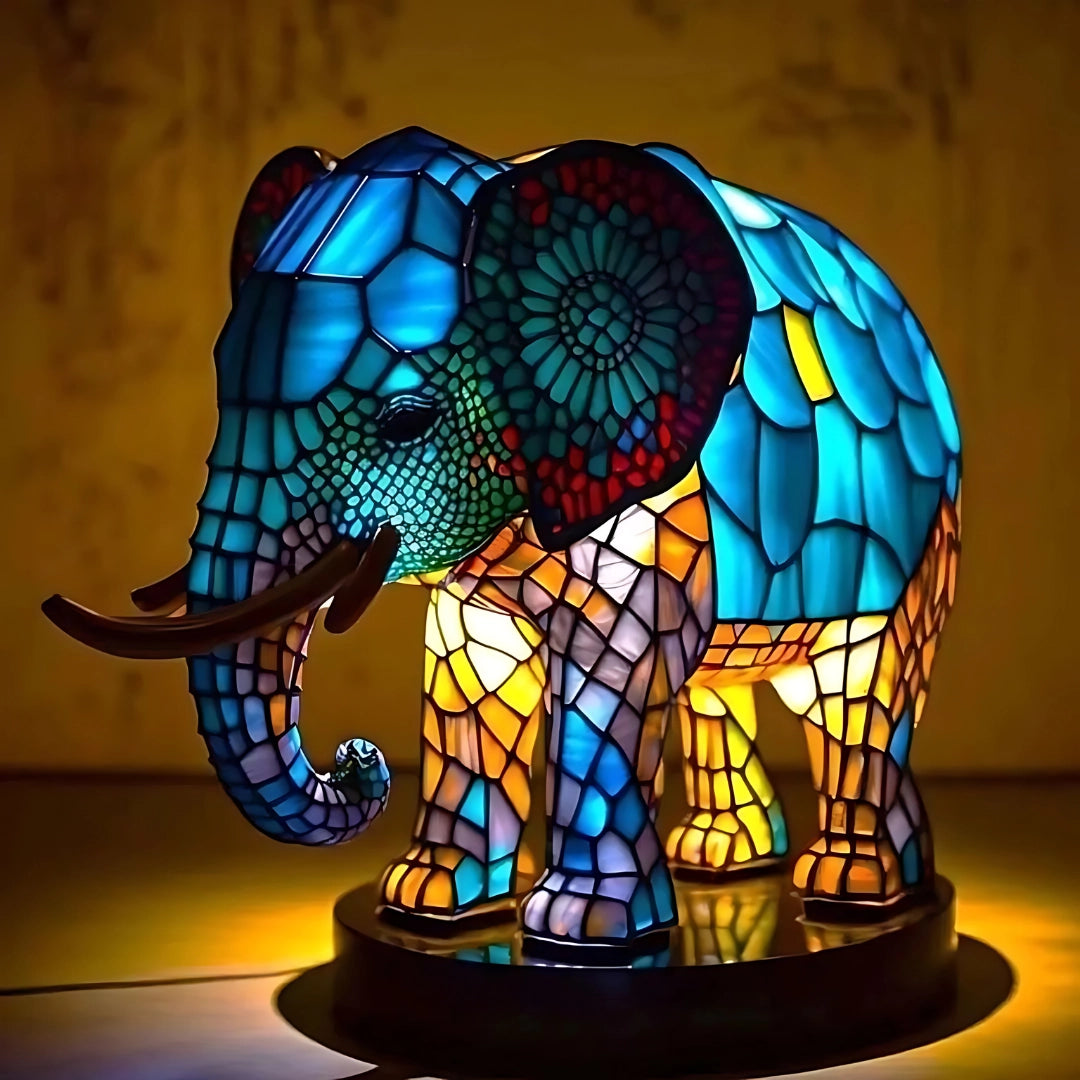 Multicolor LED stained glass night light featuring a 3D elephant design with a vibrant pattern, electric blue hues, and symmetrical stained glass artistry, illuminated in darkness.