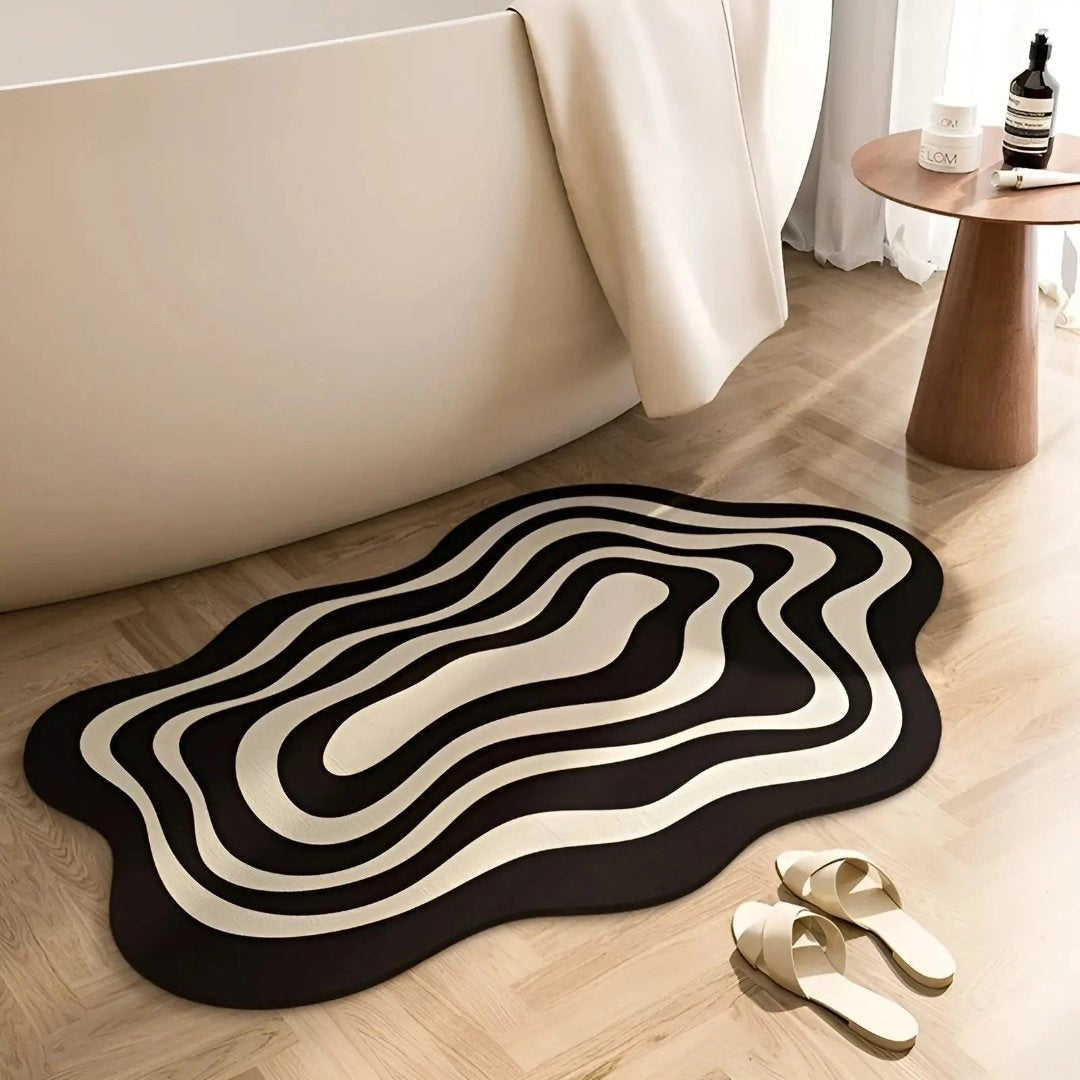 Abstract black and white contour rug displayed in a modern living room setting, featuring hardwood flooring and a minimalist interior design aesthetic.