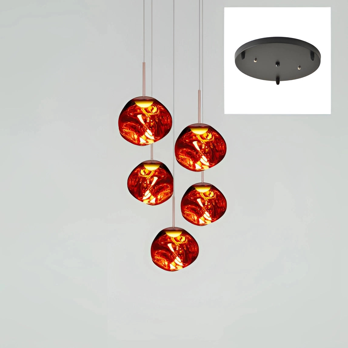 Five-headed amber glass pendant light fixture with modern copper finish, featuring round amber glass shades arranged in a circular formation, hanging from a red ceiling mount.