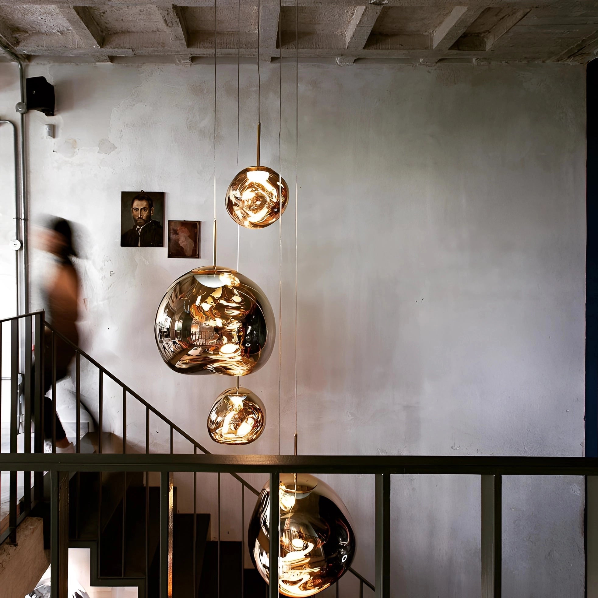 Amber glass triple pendant light fixture with modern copper ceiling lamp design, featuring three suspended glass shades in a contemporary interior setting.
