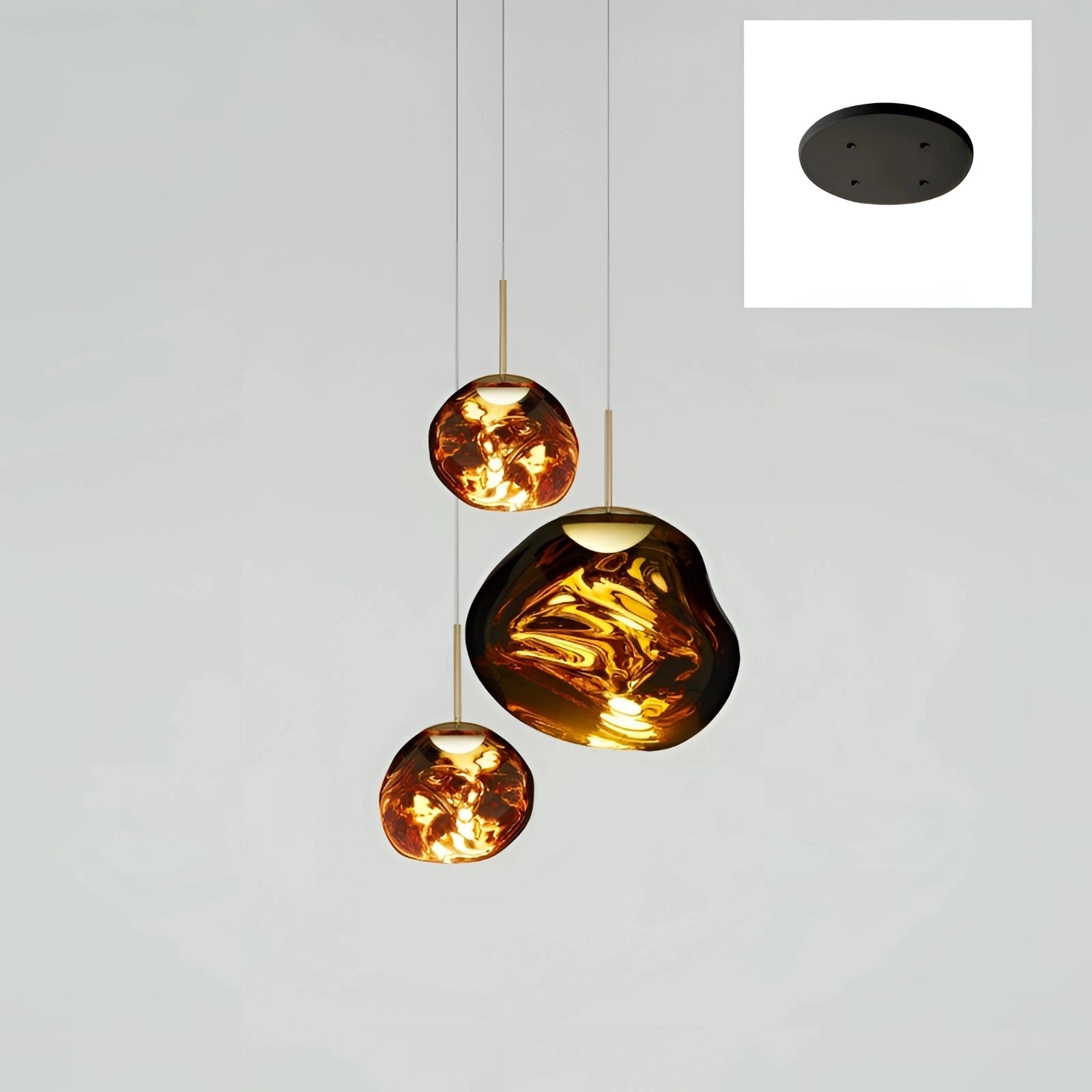 Modern copper ceiling lamp featuring a triple pendant light fixture with amber glass shades. The variant has three heads, including two measuring 28cm in diameter and one larger at 38cm, with a gold finish. The design highlights circular and oval shapes, offering an artistic and ornamental touch to interior spaces.