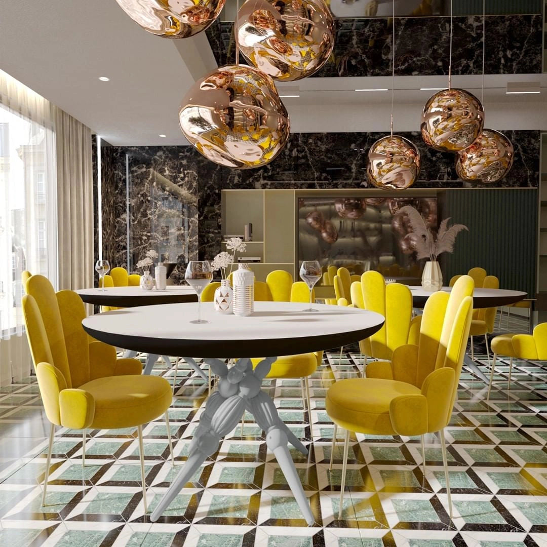Modern copper ceiling lamp with three amber glass pendant lights hanging from a ceiling, illuminating a stylishly decorated room with contemporary furniture and wooden flooring.