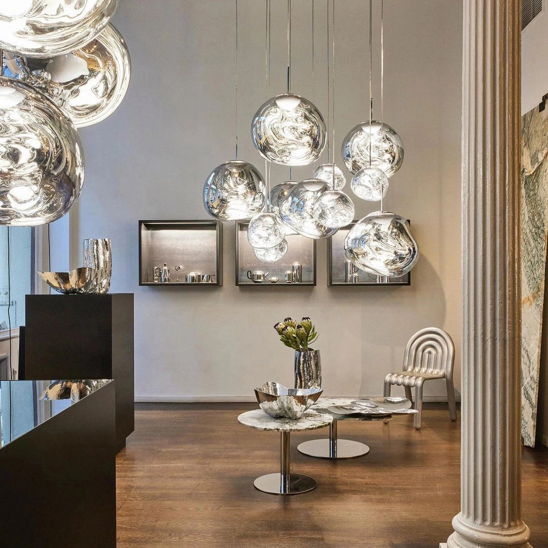 Modern copper ceiling lamp with three amber glass pendant lights, elegantly hanging and illuminating a stylish interior space, accentuating the room's contemporary decor.