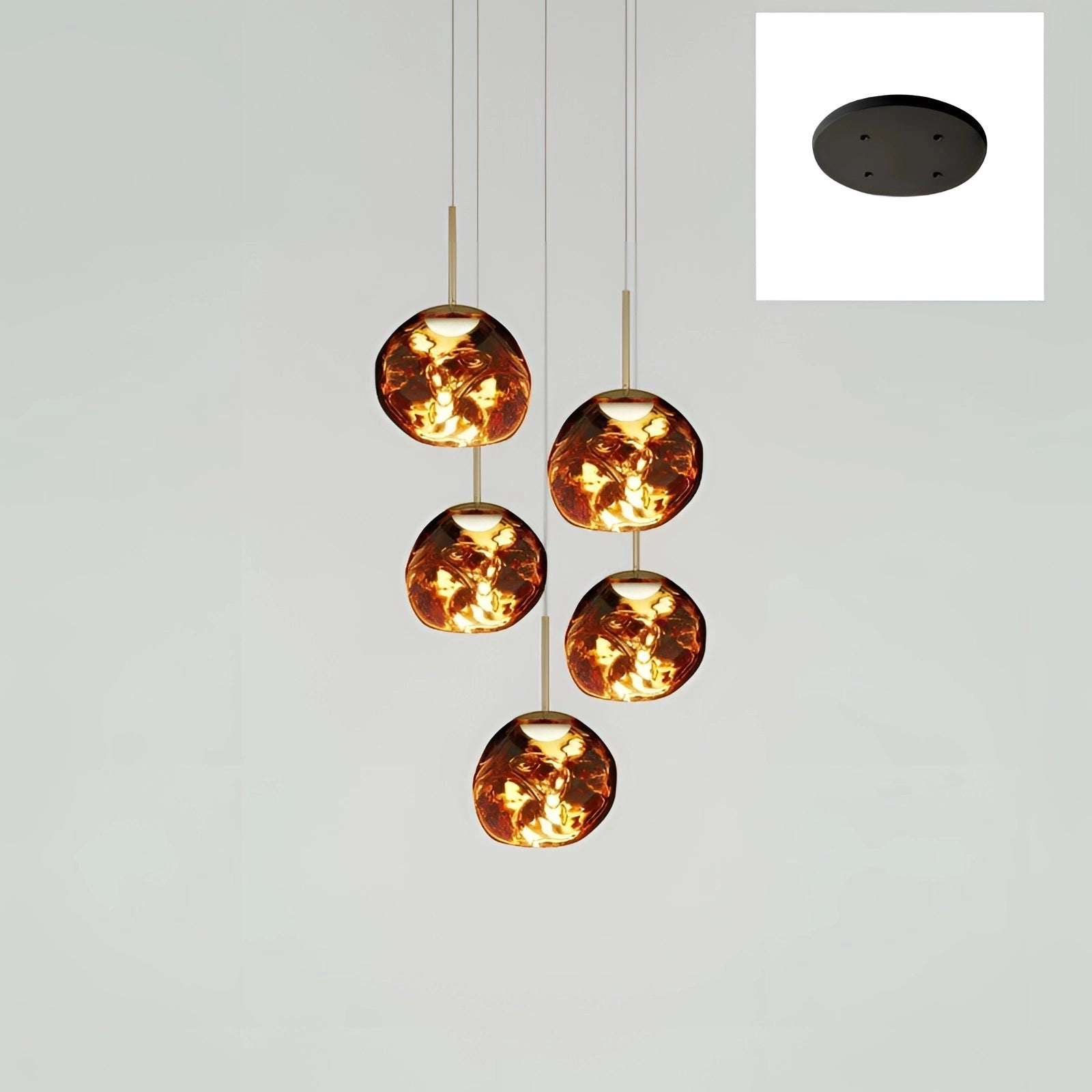 Amber glass triple pendant light fixture with five heads, featuring a modern design and a gold finish. The ceiling lamp showcases a circular arrangement, highlighting its elegant and decorative appeal.