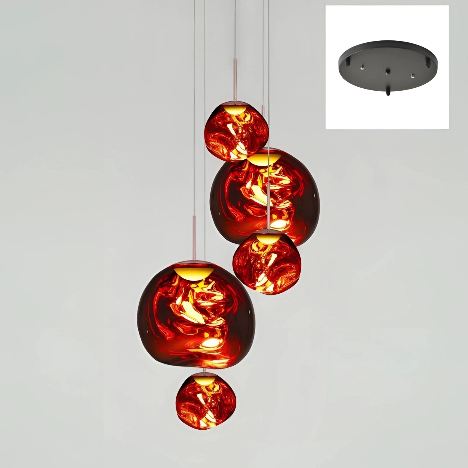 Amber glass triple pendant light fixture with a modern copper finish, featuring three spherical amber glass shades hanging from a single ceiling mount.