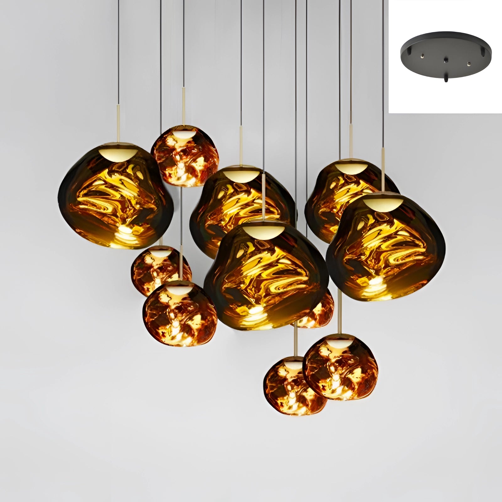 Modern amber glass triple pendant light fixture with eleven heads in a combination of 28cm and 38cm sizes, featuring a stylish gold finish. The oval-shaped lamps create warm, artistic lighting, ideal for contemporary interiors.