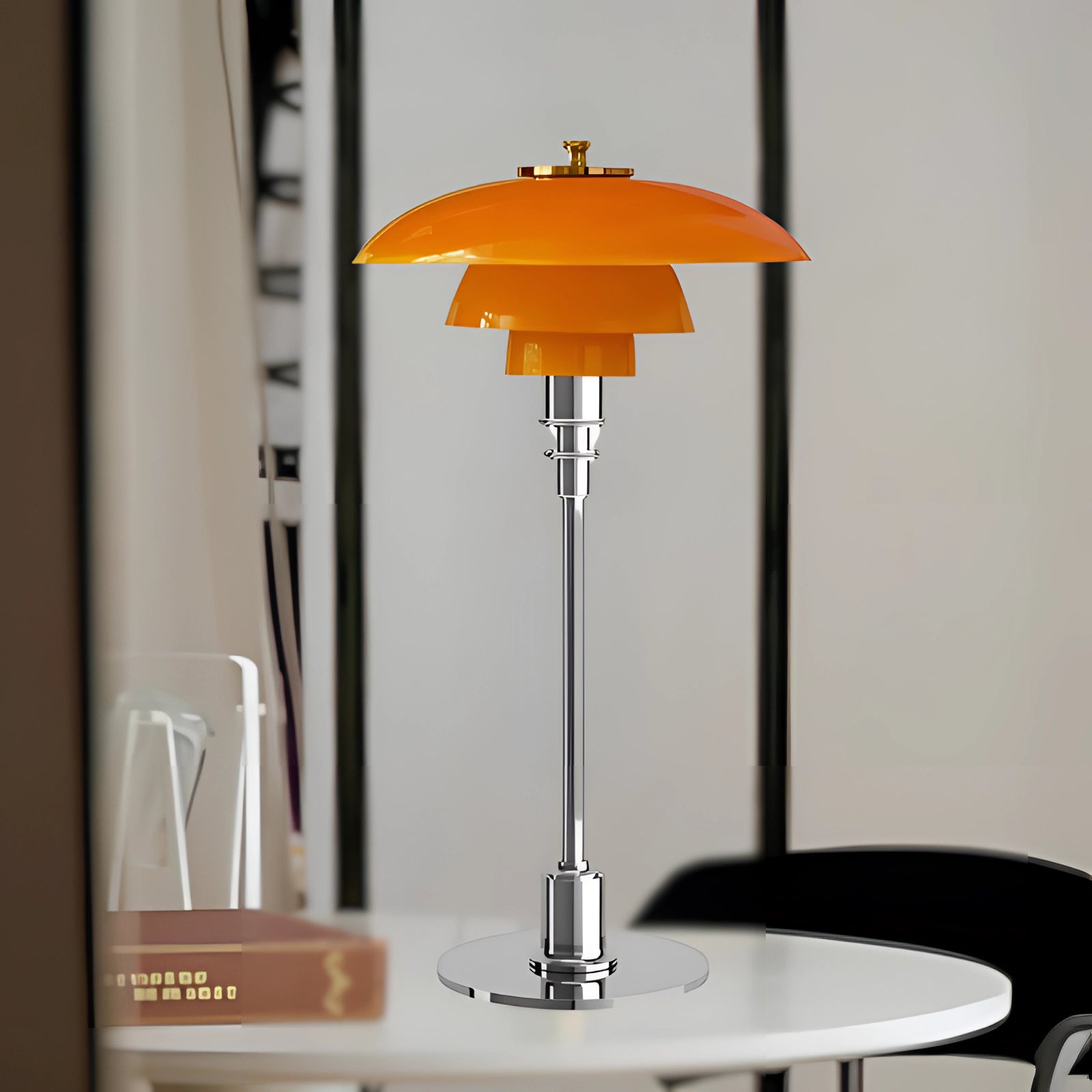 Art-Deco orange glass table lamp with a vintage brass base featuring an amber-silver finish. The lamp has a stylish glass lampshade that adds a warm glow, ideal for a home office setting.