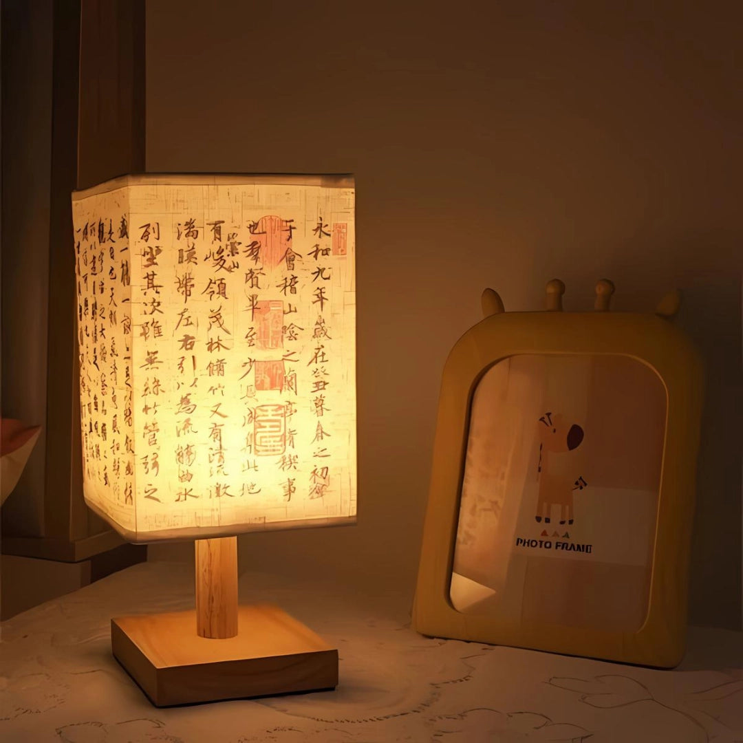 Asian-inspired wooden table lamp featuring a parchment lampshade, combining traditional design elements with contemporary style. The lamp showcases intricate wood craftsmanship, offering a warm and inviting ambient lighting solution.