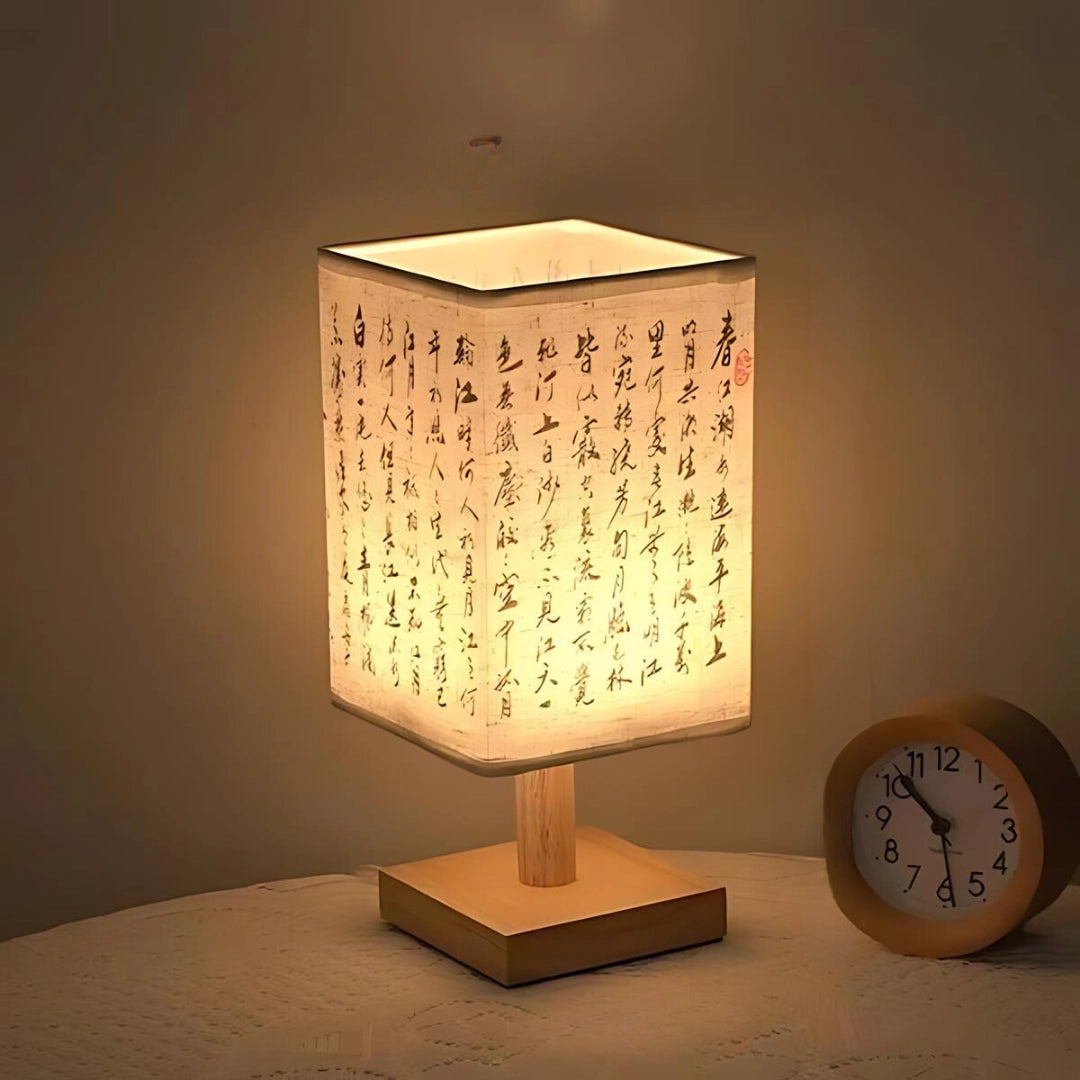 Asian-Inspired Wooden Table Lamp with a rectangular wooden base and an amber-toned parchment lampshade.
