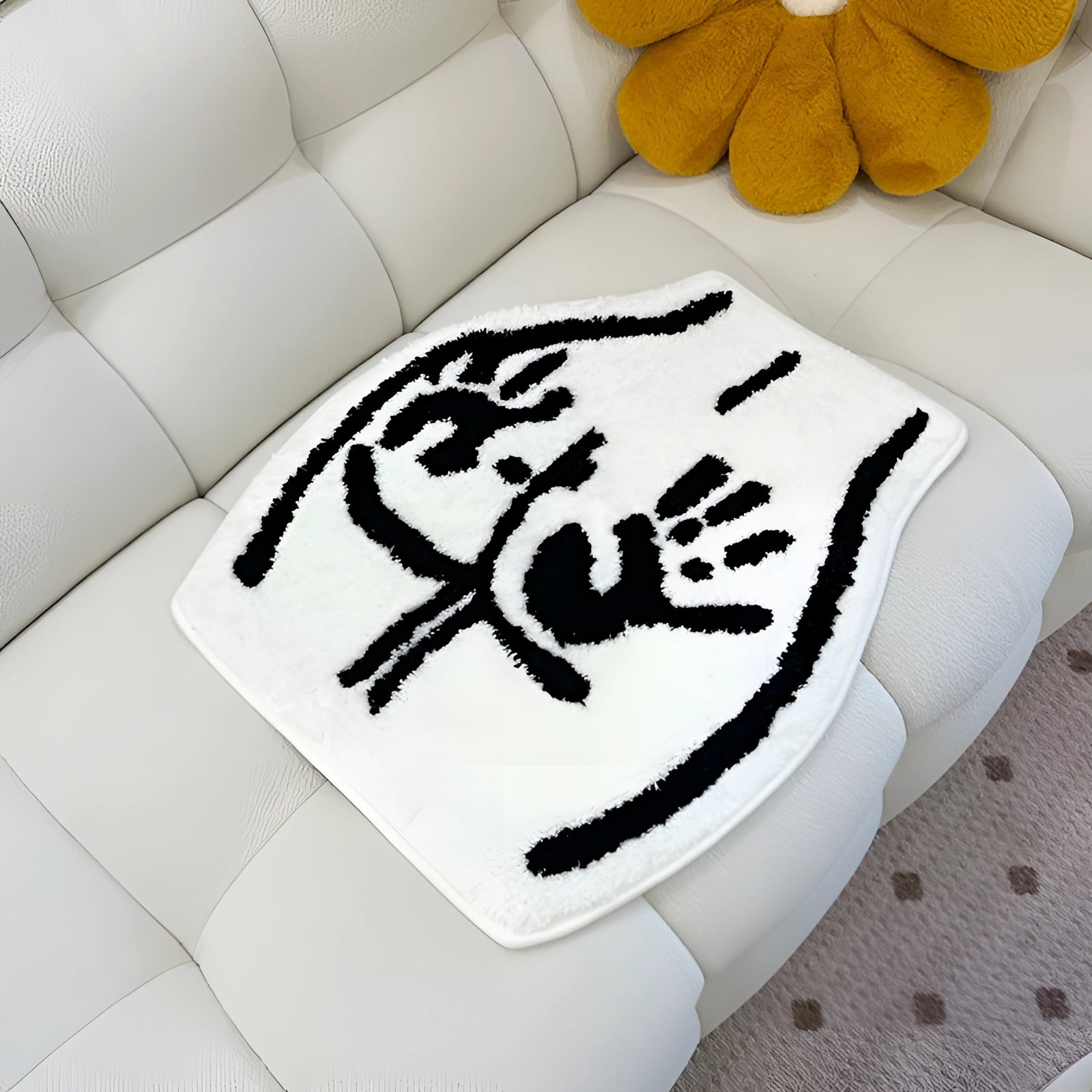 A rectangular white rug featuring a wildlife-inspired bear paw print pattern, designed to resemble an animal footprint.