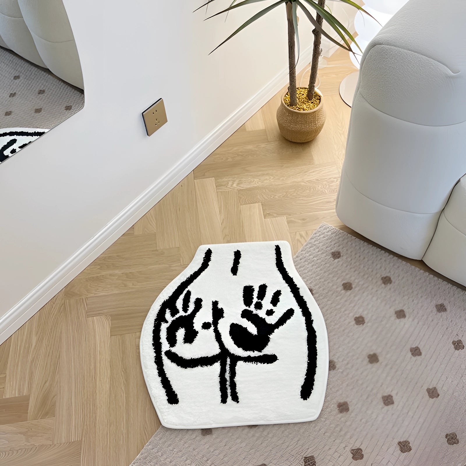 Bear paw print rug with wildlife-inspired animal footprint design placed on a wooden floor next to a white flowerpot and green plant, enhancing the interior decor.