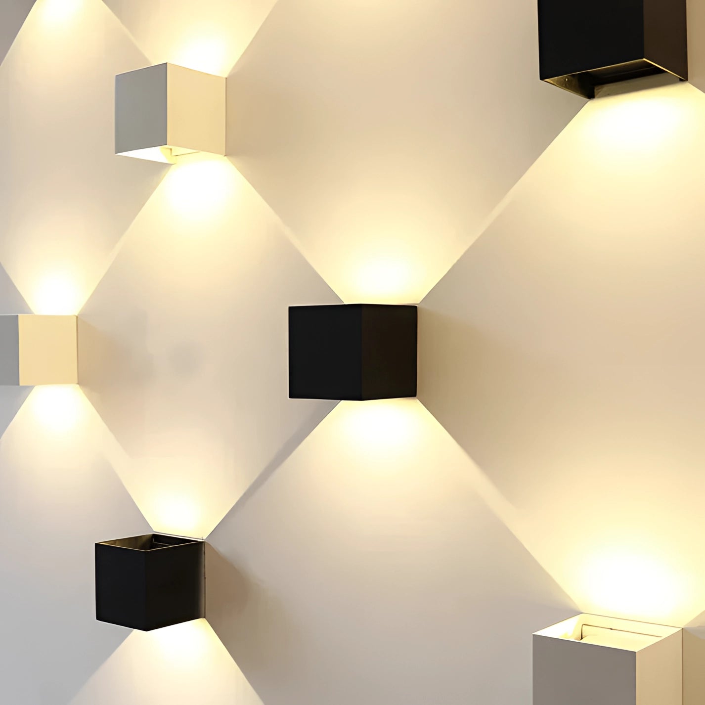 A modern minimalist black cube organizer used as a storage box, featuring sleek lines and a rectangular shape, placed in a well-lit interior setting with warm wood accents and yellow lighting.