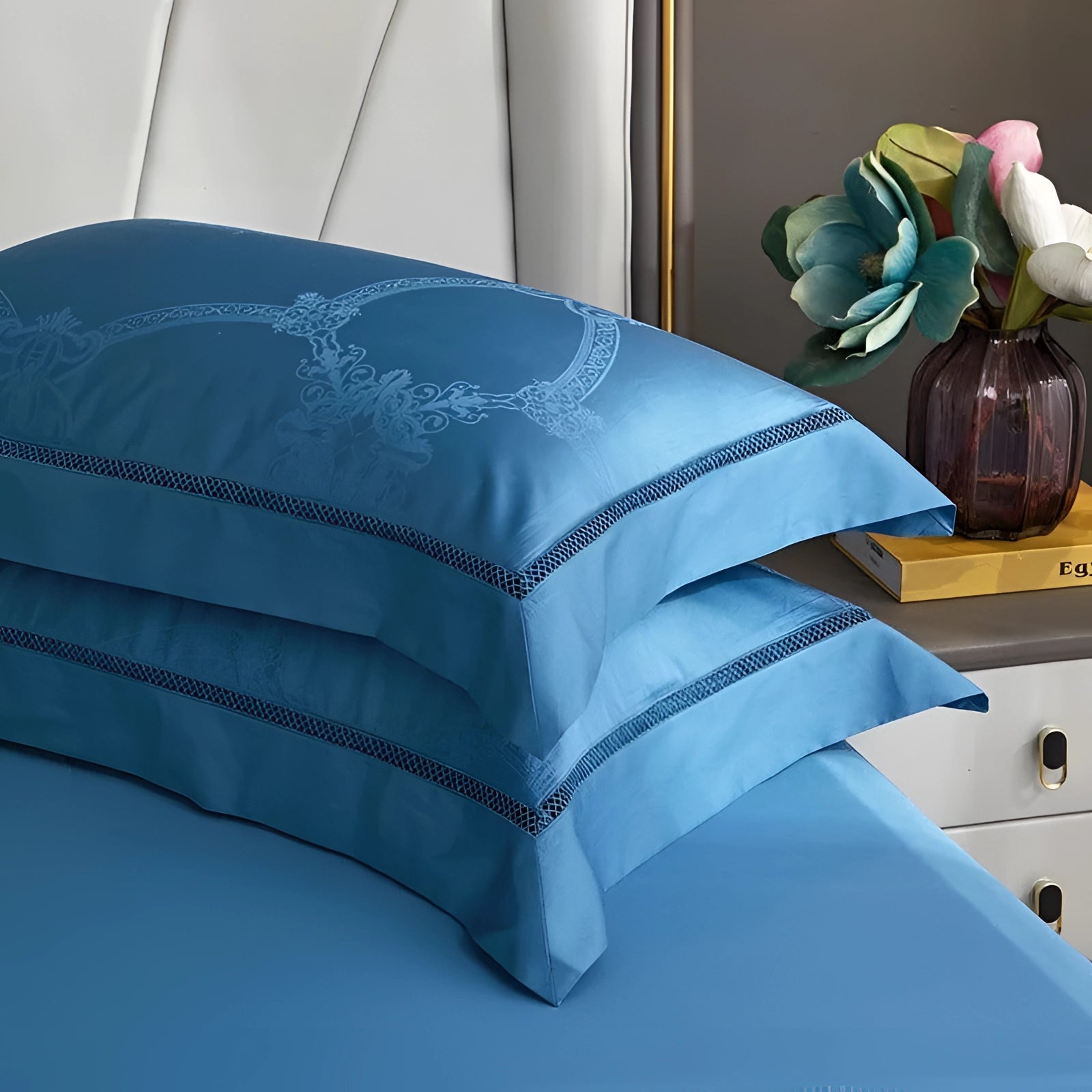 Luxurious blue king size silk bedsheet set displayed in a bedroom setting, featuring a rich azure color with matching pillowcases, providing a wrinkle-free and hypoallergenic sleeping experience.
