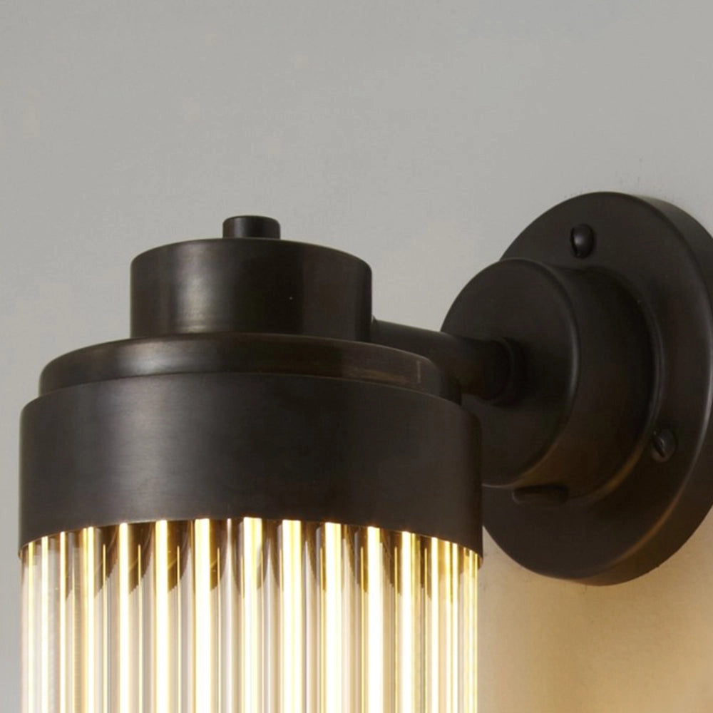 Bronze Vintage Glass Tube Wall Sconce with industrial design, featuring a cylindrical glass tube and metal accents, suitable for bathroom lighting.