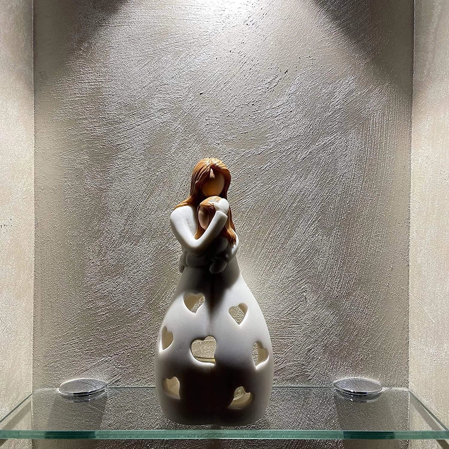 Ceramic lamp with a heart pattern design, emitting a warm glow, ideal for creating a romantic atmosphere in a couple's room.