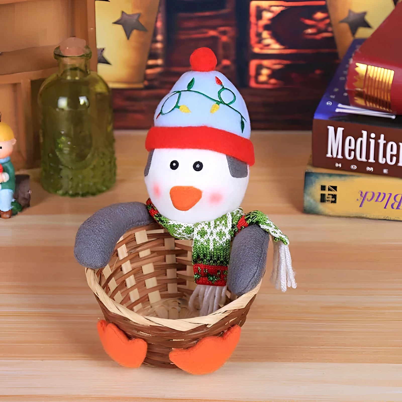 Festive kitchen decor gift basket featuring a gingerbread man plush dressed in a penguin costume, surrounded by Christmas-themed ornaments and decorations, including a Santa Claus figurine and a cone-shaped garden gnome ornament.