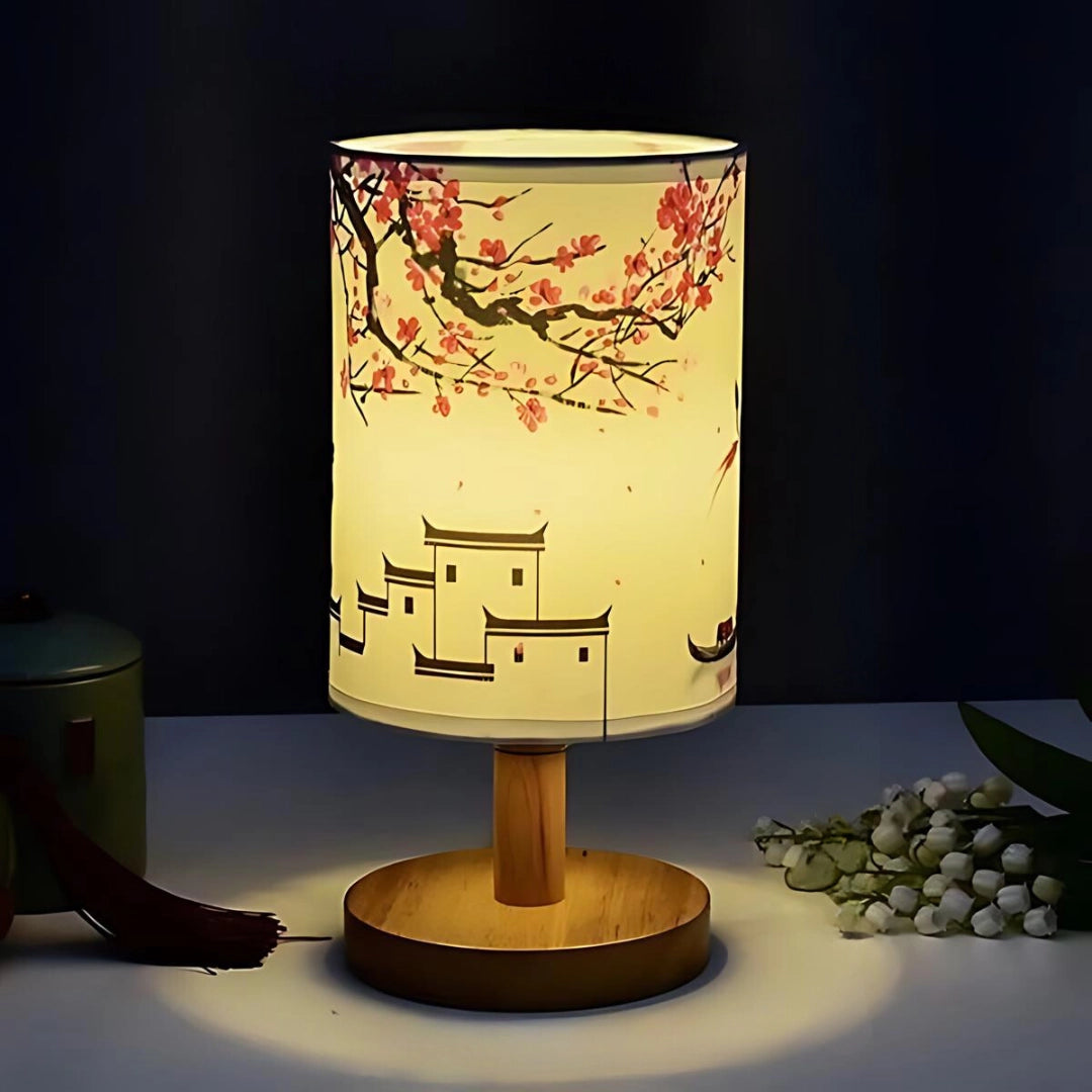 Cherry Blossom Table Lamp with a Sakura design, featuring a wooden base and glass lampshade resembling a subtle floral pattern, emitting a gentle light suitable for night-time ambiance on a table.