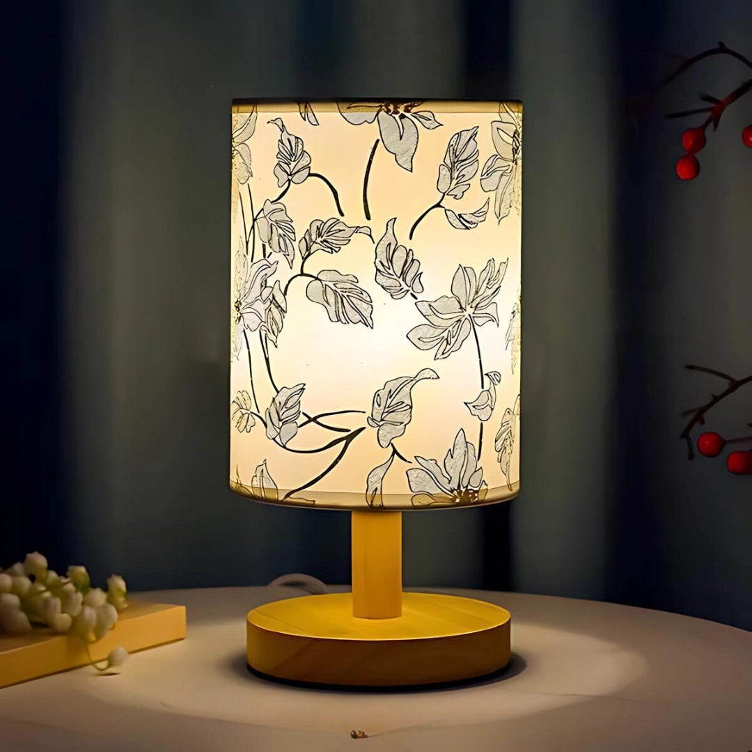 Cherry Blossom Table Lamp with Sakura-shaped glass blossoms illuminated on a wooden base, showcasing artistic design and natural aesthetics.