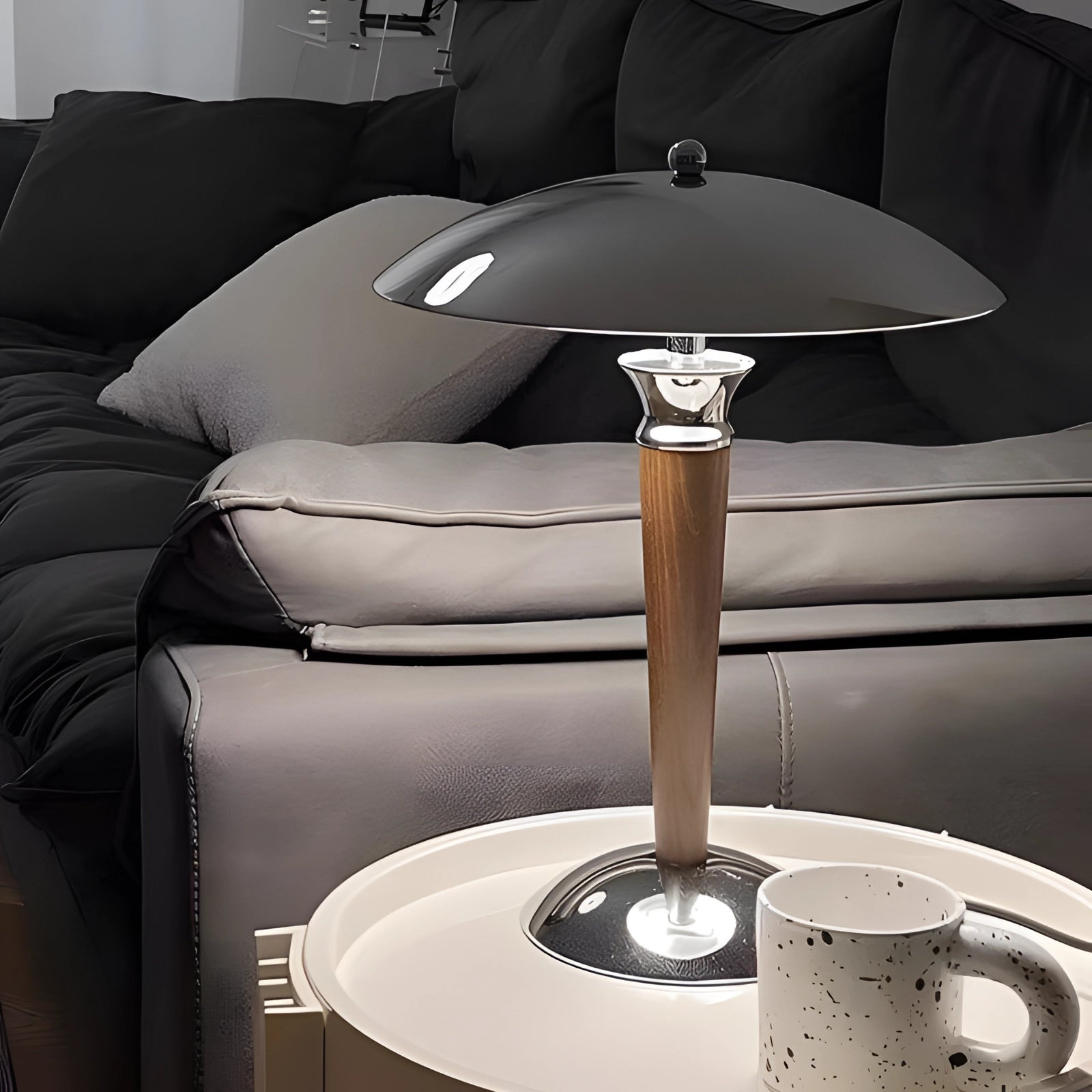 Chrome finish metal table lamp with adjustable dimmer, featuring a sleek and modern design, elegantly illuminating a table setting within an interior space.