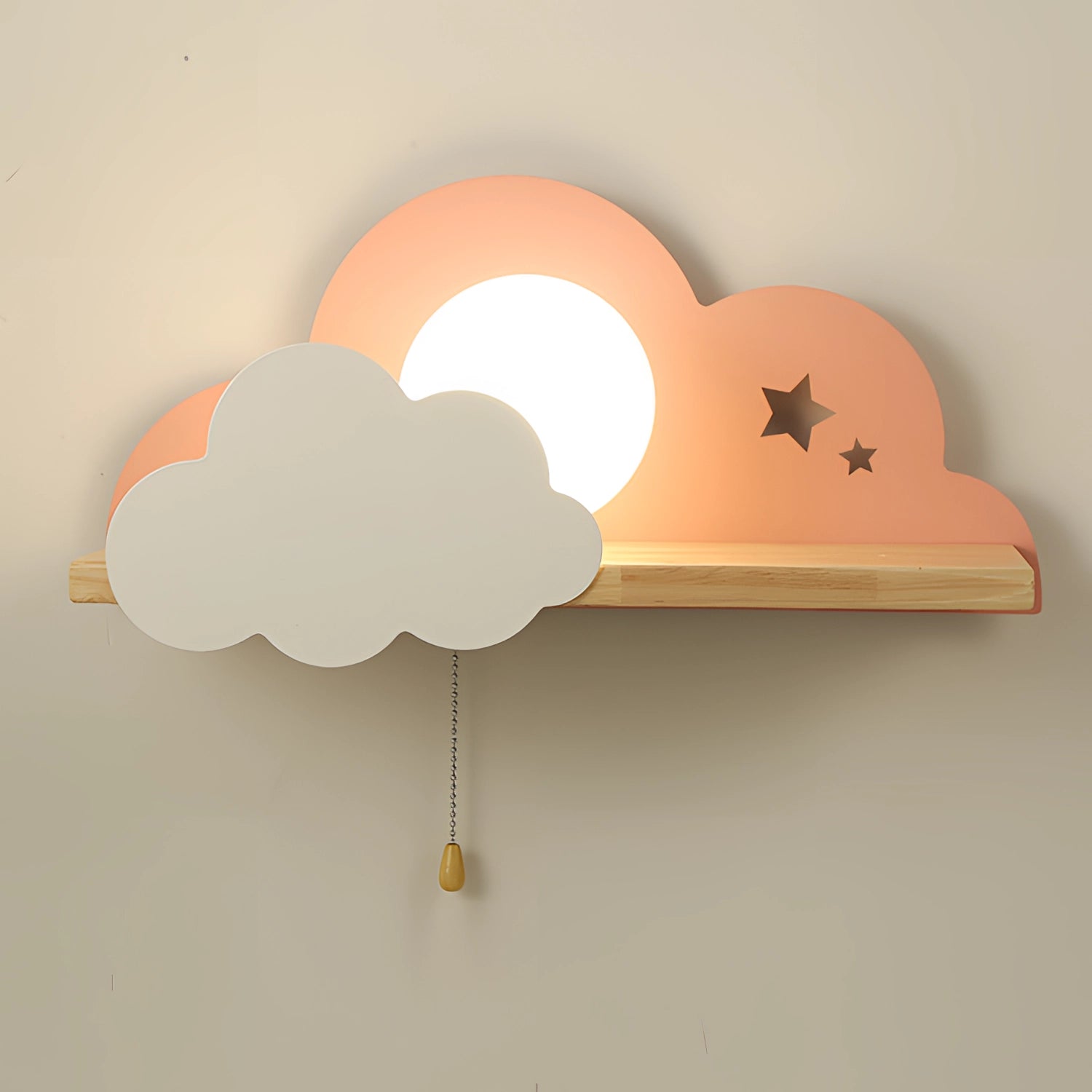 Cloud-shaped LED wall lamp with a pink finish, designed for children's rooms, featuring star cutouts. Suitable for 220 V-240 V power supply in Great Britain and Australia. The lamp is mounted on a wooden base, creating a whimsical and artistic ambiance, perfect for a cozy nightlight.