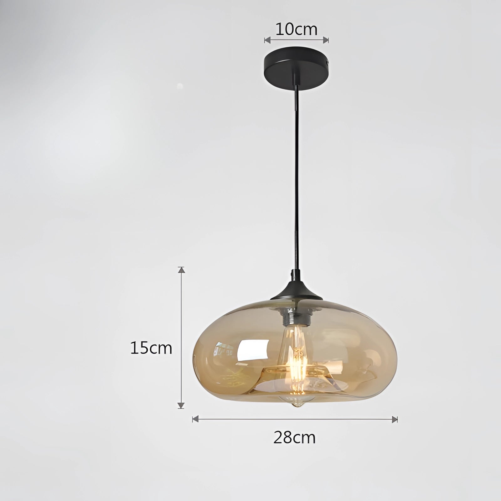 Amber-colored glass pendant light with a mid-century modern design, featuring a warm white glow, metal accents, and a circular shape, suspended from a ceiling as part of interior decor.
