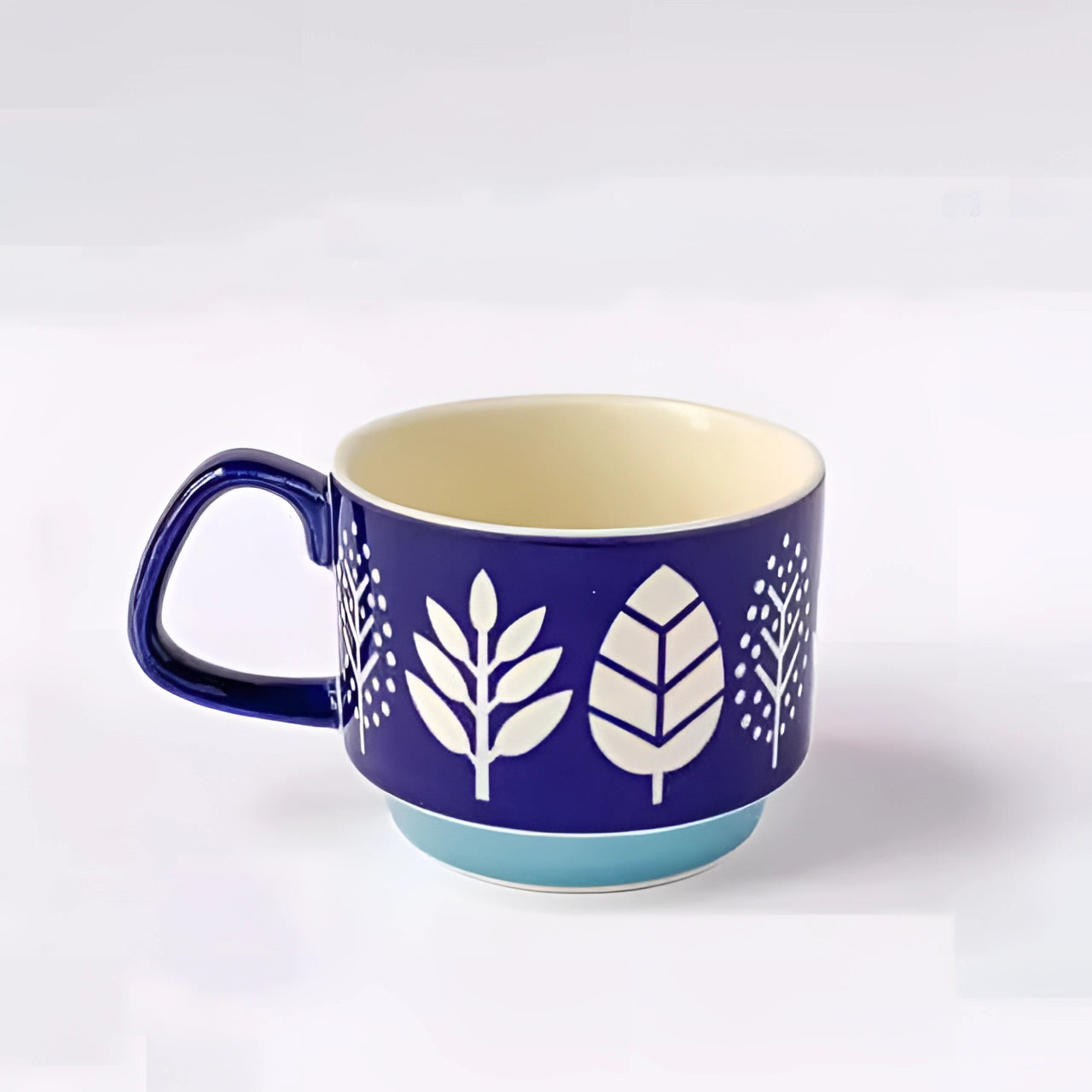 A colorful ceramic mug featuring vibrant polka dots, a red handle, and a blue base, designed for serving hot beverages such as coffee or tea.