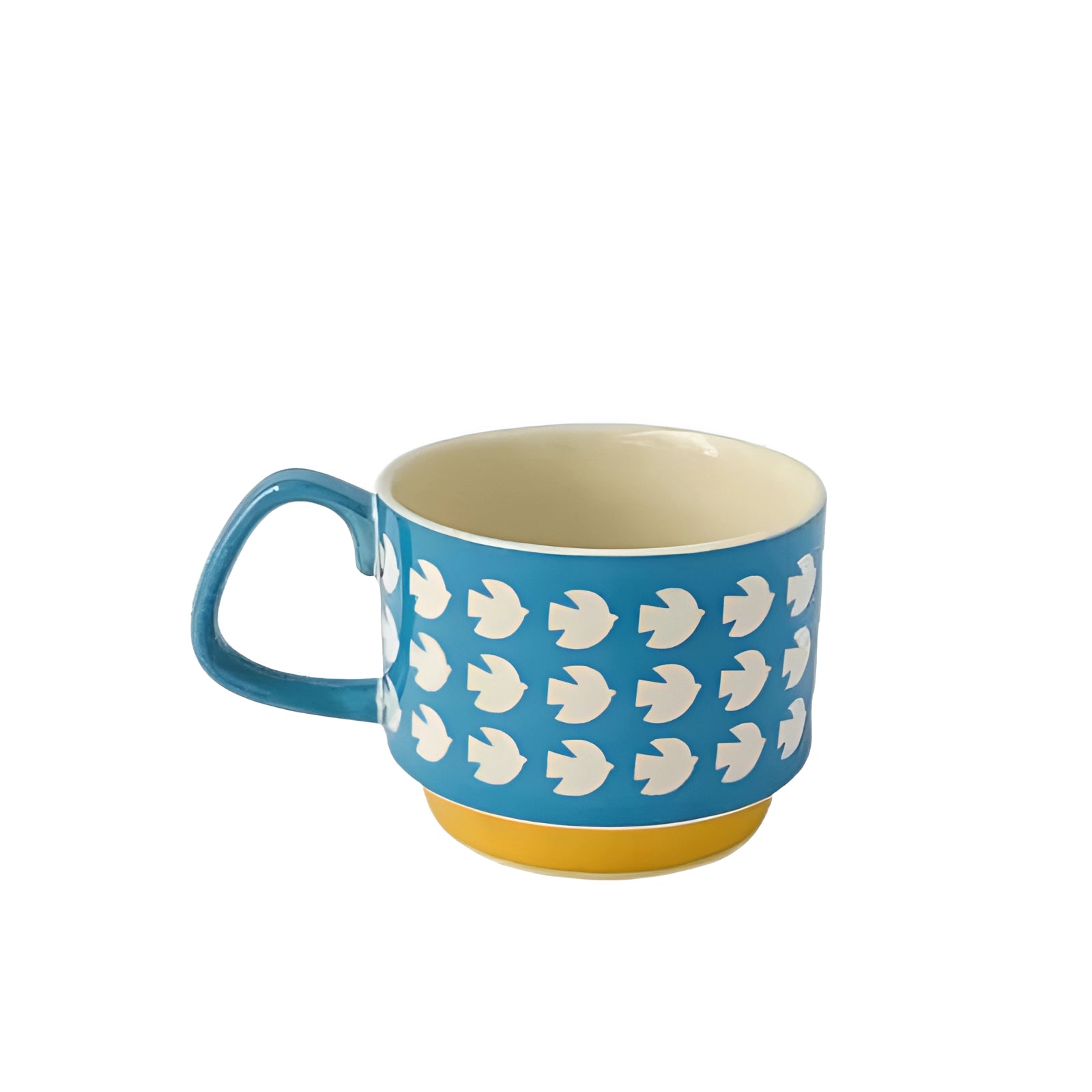 Colorful polka dot ceramic mug with a red handle and blue base, featuring a design of white doves on a blue background.