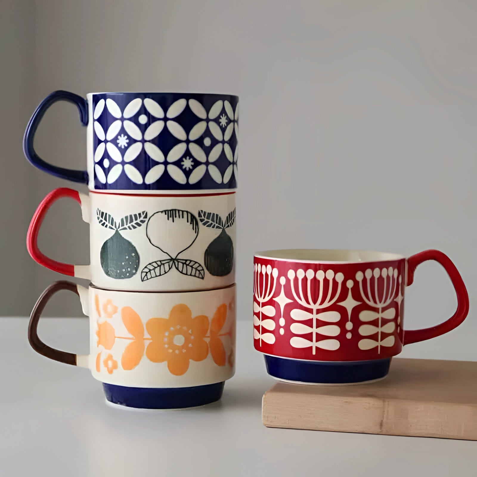 A ceramic mug with colorful polka dots, featuring a red handle and a blue base, suitable for use as tableware or drinkware.