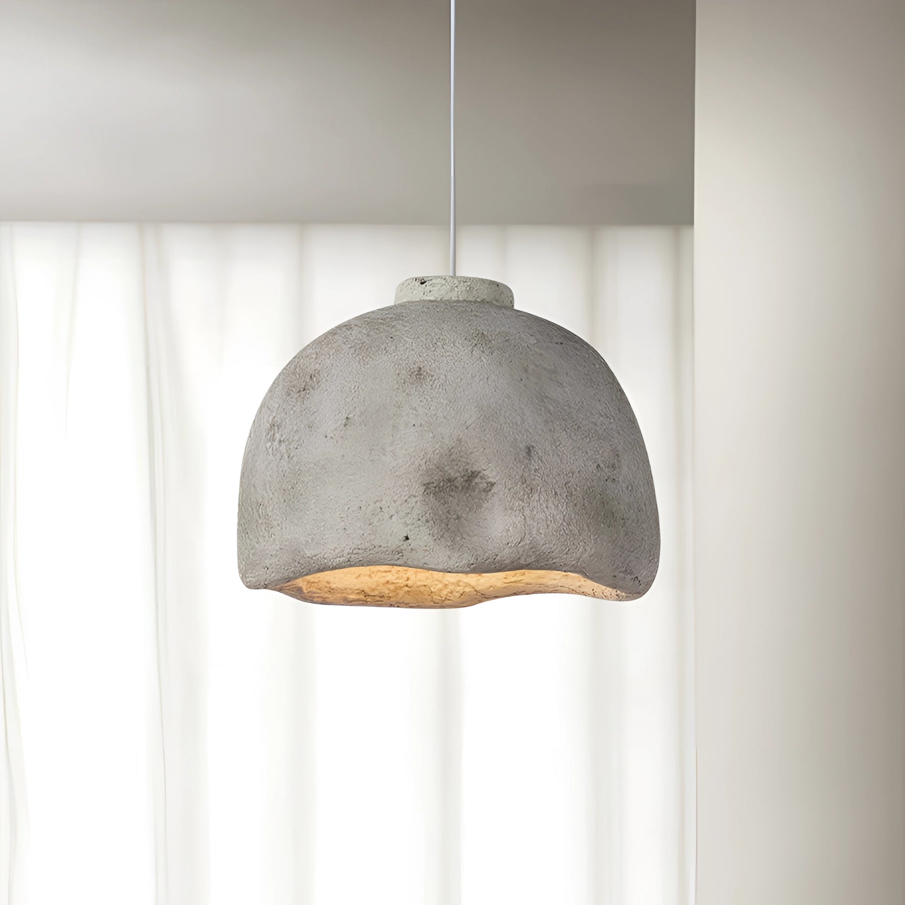 Concrete pendant light with a minimalist design in a 17.7-inch size, featuring a gray finish, suitable for industrial and eco-friendly decors, hanging from a ceiling.