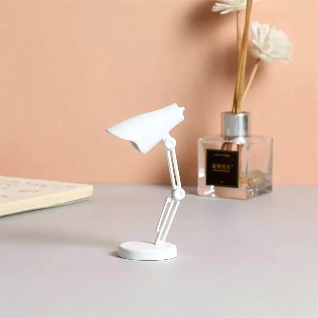 A stylish Coral Mini LED Adjustable Desk Lamp in white, featuring a sleek modern design with mixed materials including metal and plastic, suitable for enhancing office or home lighting decor.