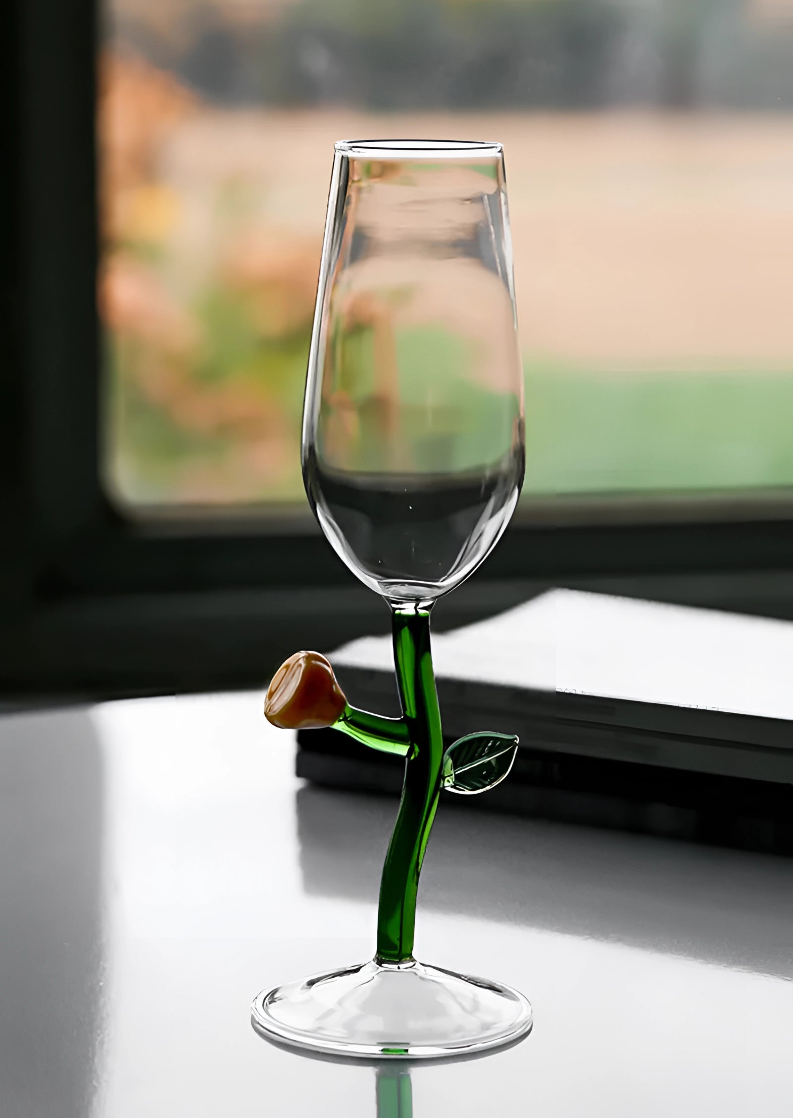A set of decorative, handcrafted vineyard wine glasses filled with liquid, placed on a table.