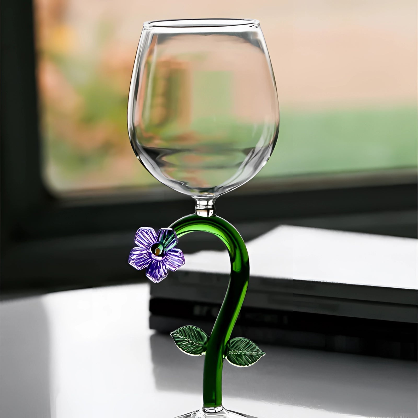A set of decorative artistic handcrafted vineyard wine glasses displayed on a table, designed with elegant stemware suitable for both wine and champagne.