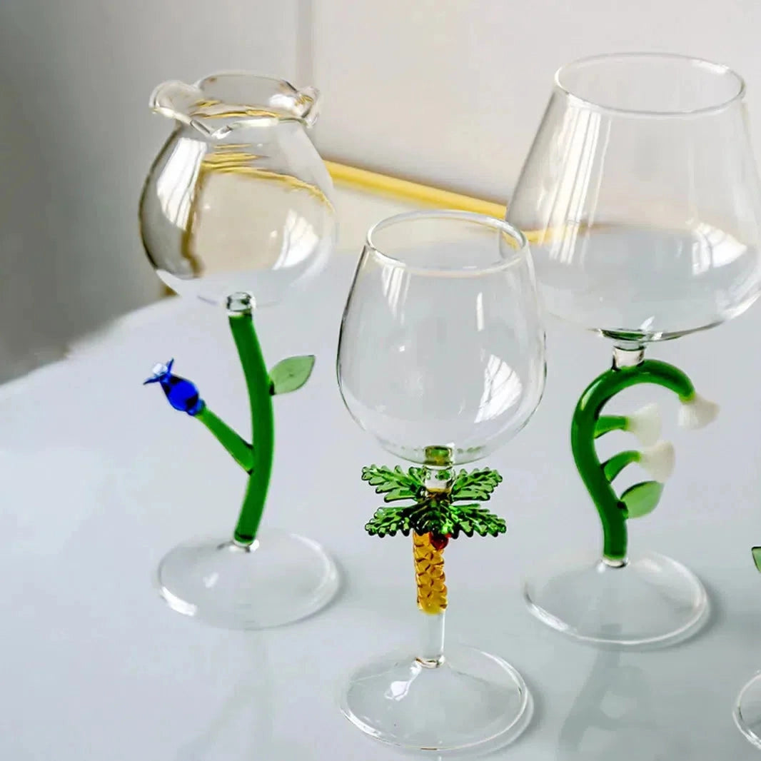 Decorative Artistic Handcrafted Vineyard Wine Glasses Set featuring elegant white and green stemware on a table.