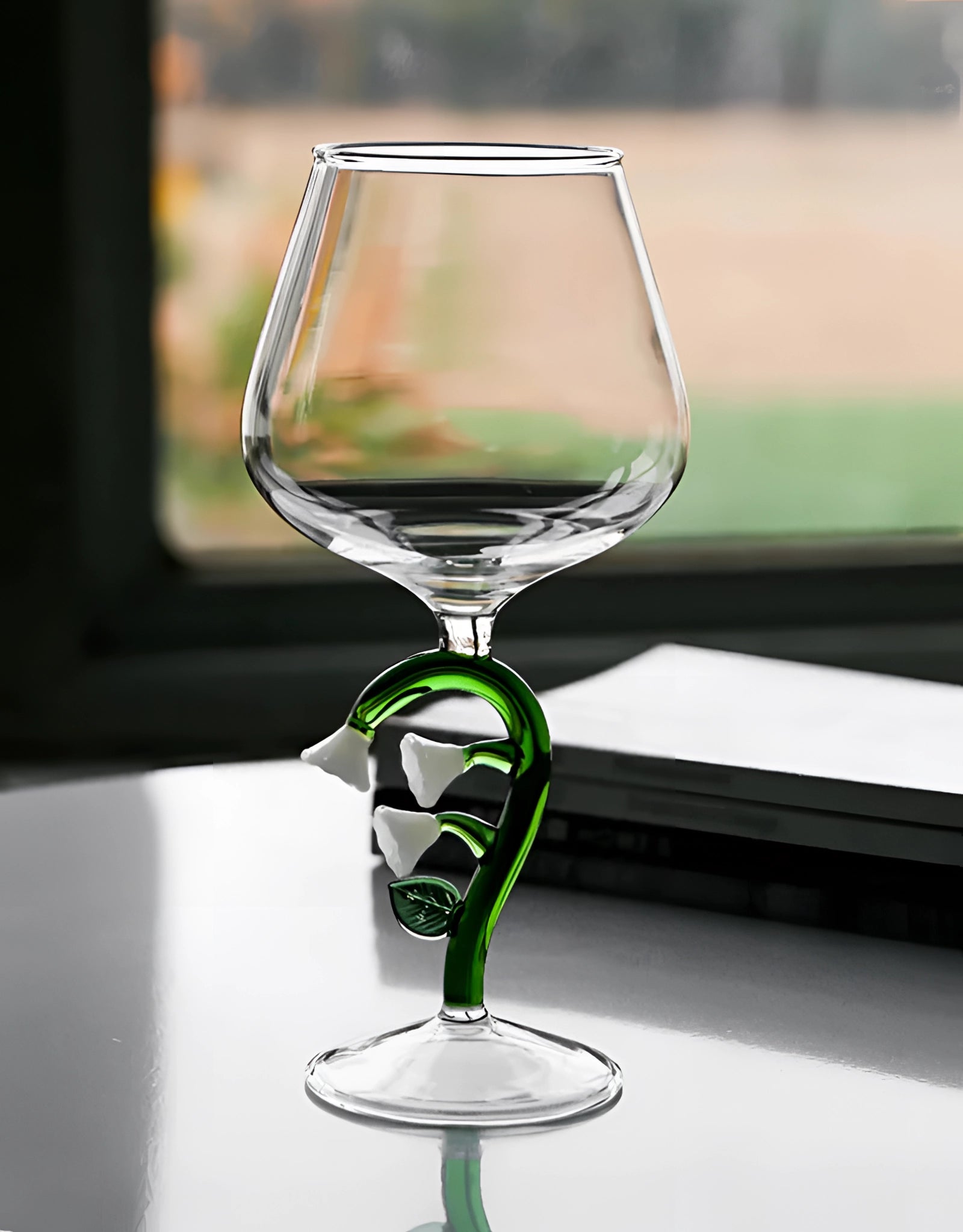 A set of decorative artistic handcrafted vineyard wine glasses displayed on a table, showcasing elegant stemware suitable for enjoying wine or champagne.