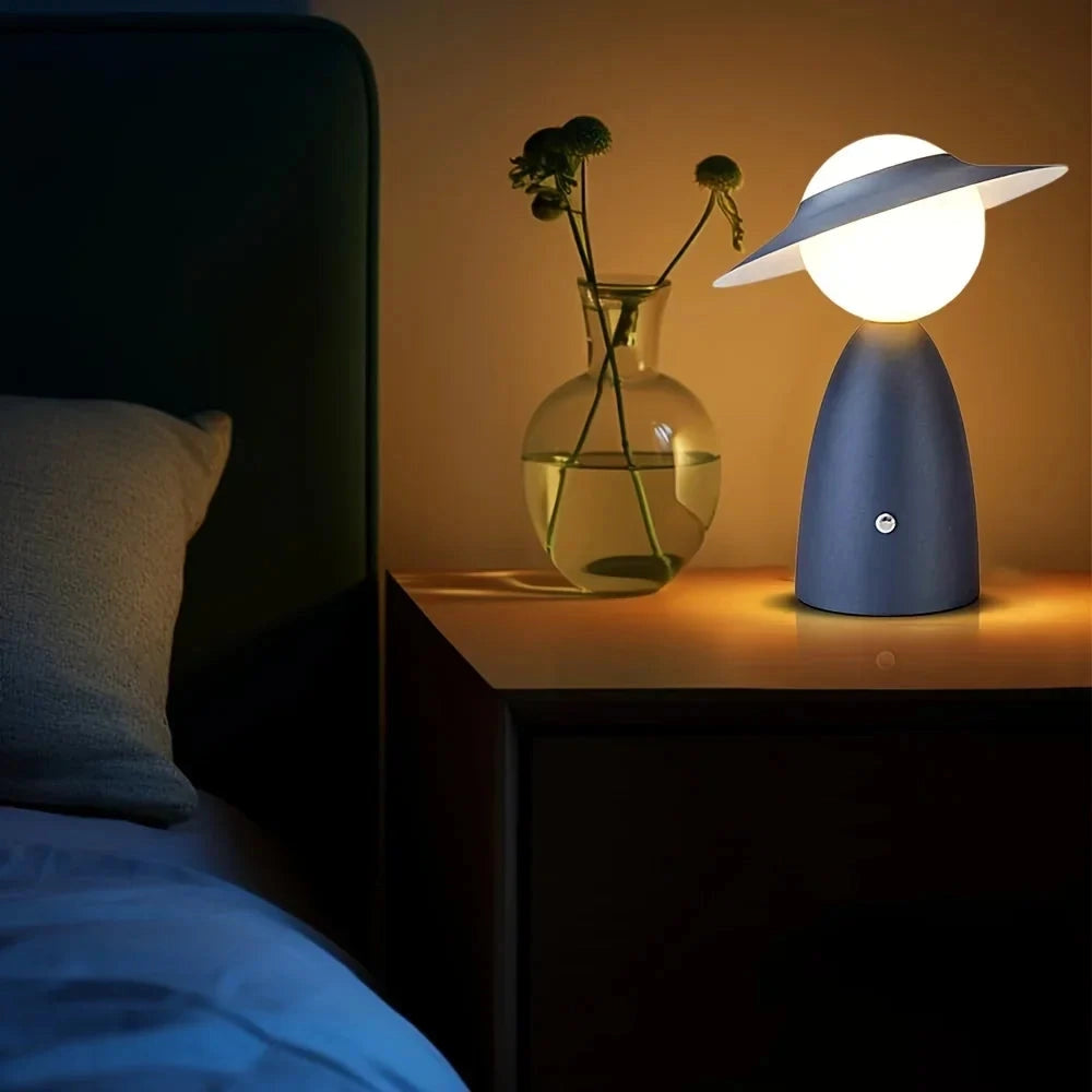 Modern UFO-shaped Designer Mushroom Lamp on a wooden bedside table, illuminating the room with artistic lighting. Decor elements include a small plant, contributing to a cozy interior design.