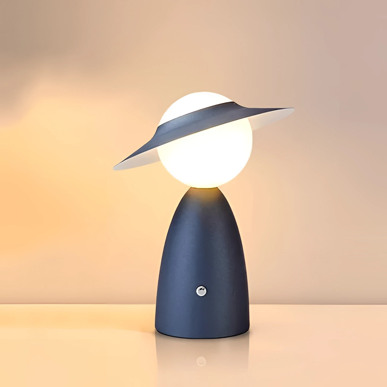 Modern blue UFO-shaped designer mushroom lamp on a desk, serving as artistic bedside lighting.