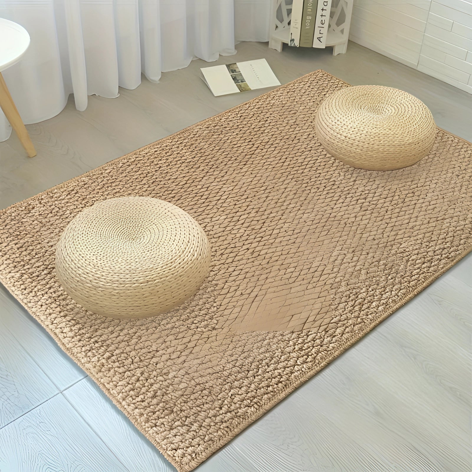 Beige indoor rectangular doormat placed on a hardwood floor in a well-designed interior space.