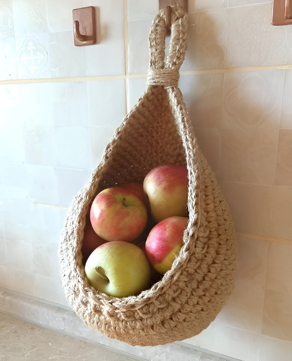 Eco-friendly jute hanging basket filled with fresh pears and pomegranates, showcasing a rustic and boho chic decor style.