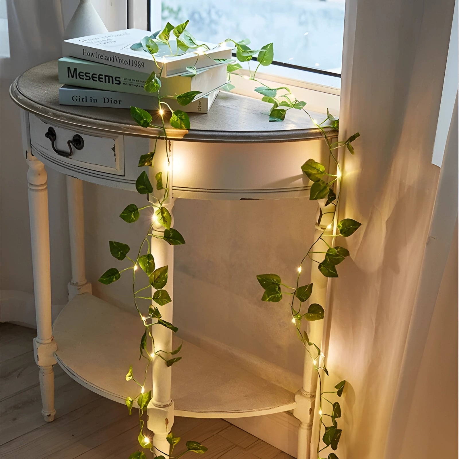 Eco-friendly LED ivy fairy lights draped artistically over a wooden table, enhancing interior design with a natural vine appearance, suitable for home decor or event settings.