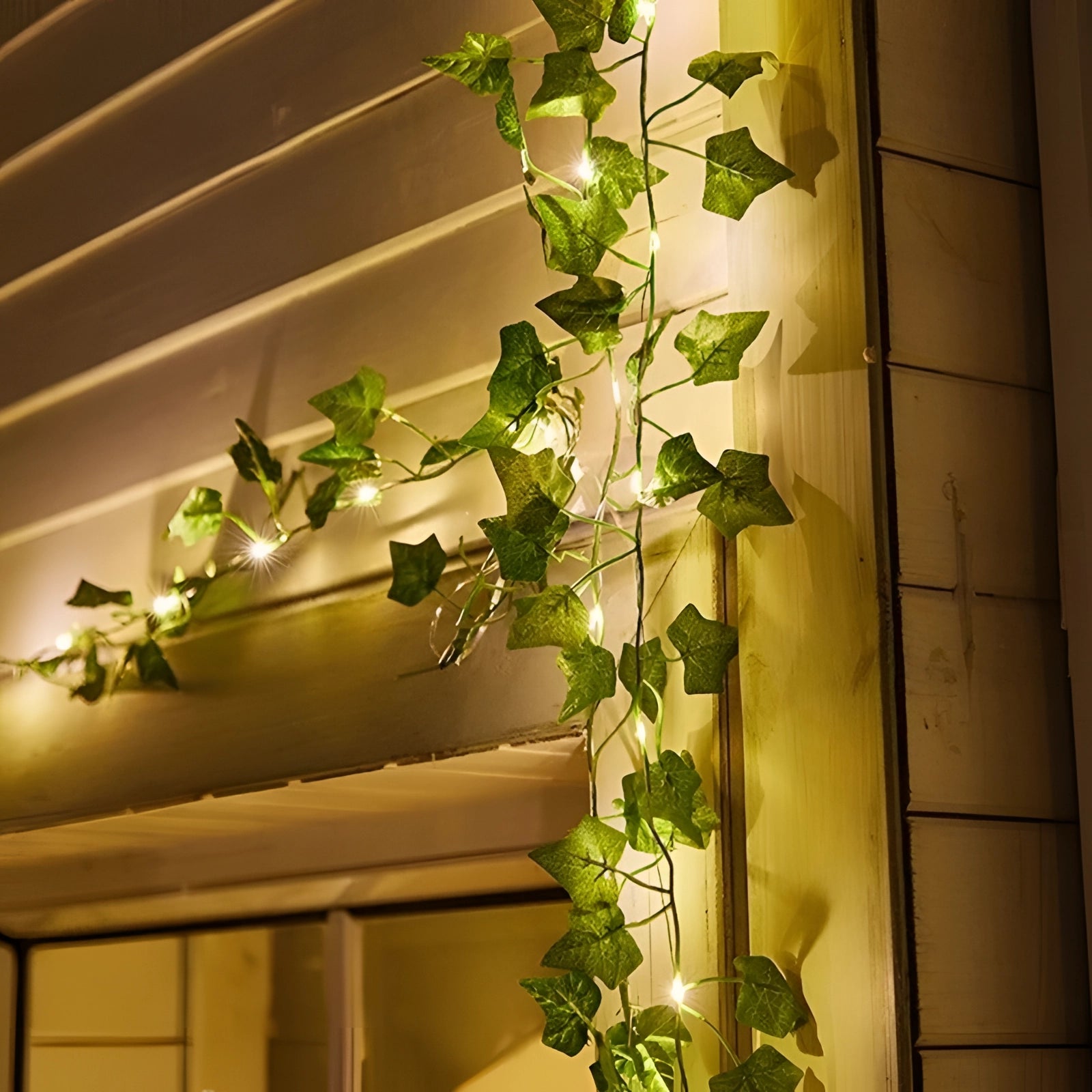 Eco-friendly battery-operated LED ivy fairy lights intertwined with realistic vine and leaf design, creating a natural and ambient lighting effect suitable for home decor or special events.