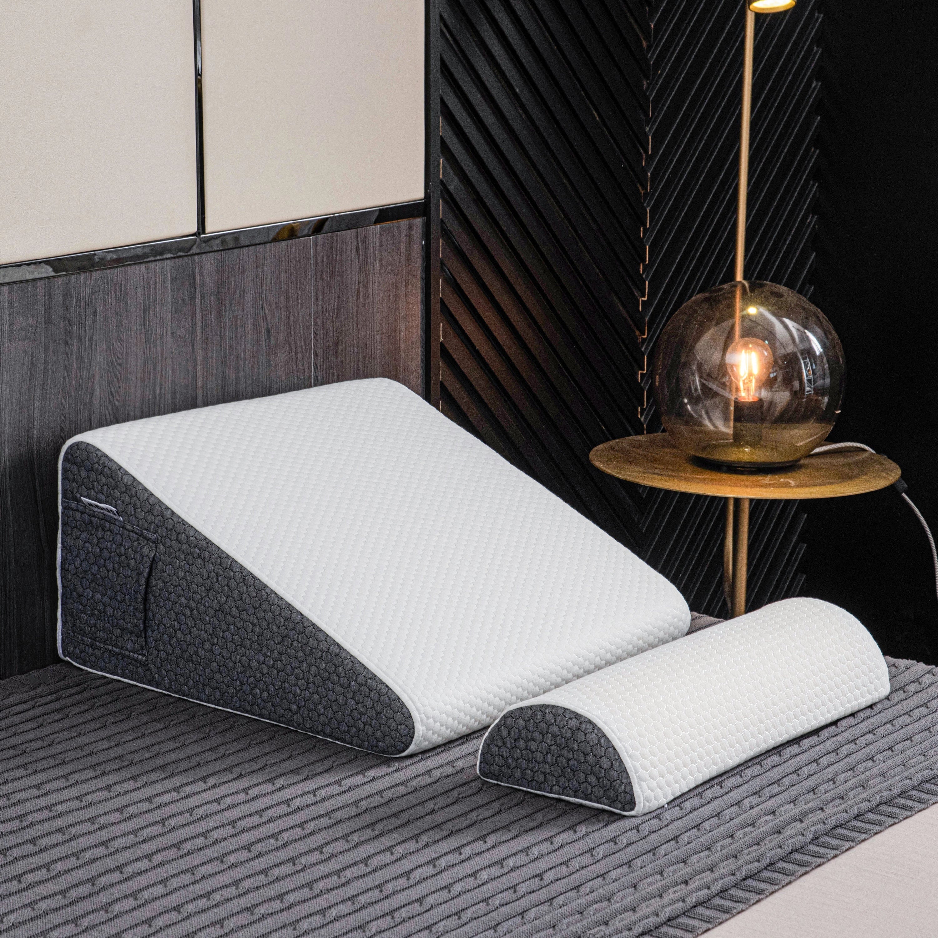 Ergonomic memory foam neck support pillow placed on a wooden table, showcasing its rectangular shape and comfortable design, in a well-lit interior setting with a floor lamp in the background.
