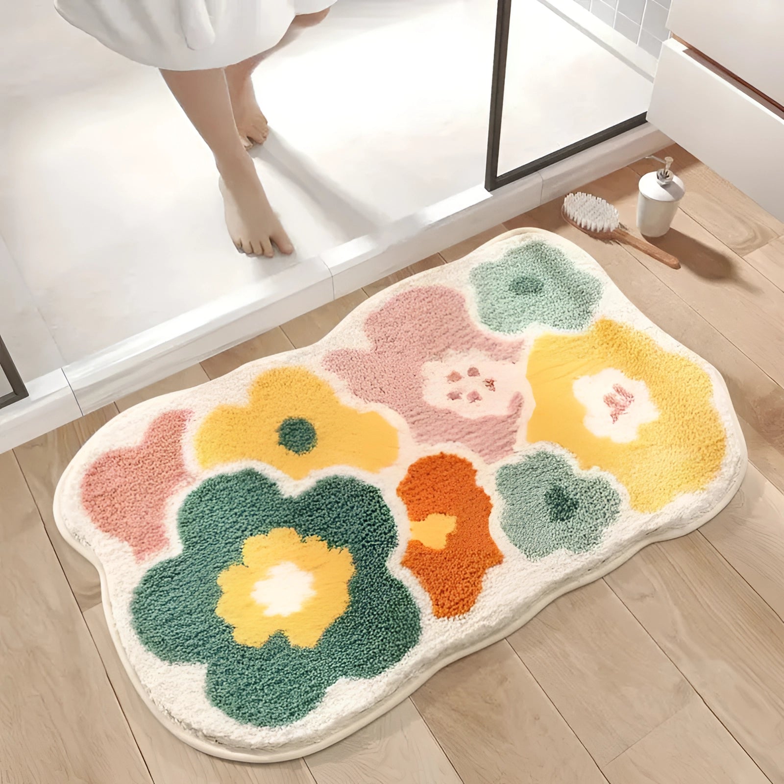 Colorful floral non-slip bath rug in a rectangular shape placed on a wooden floor, showcasing a soft and decorative textile design with vibrant orange hues.