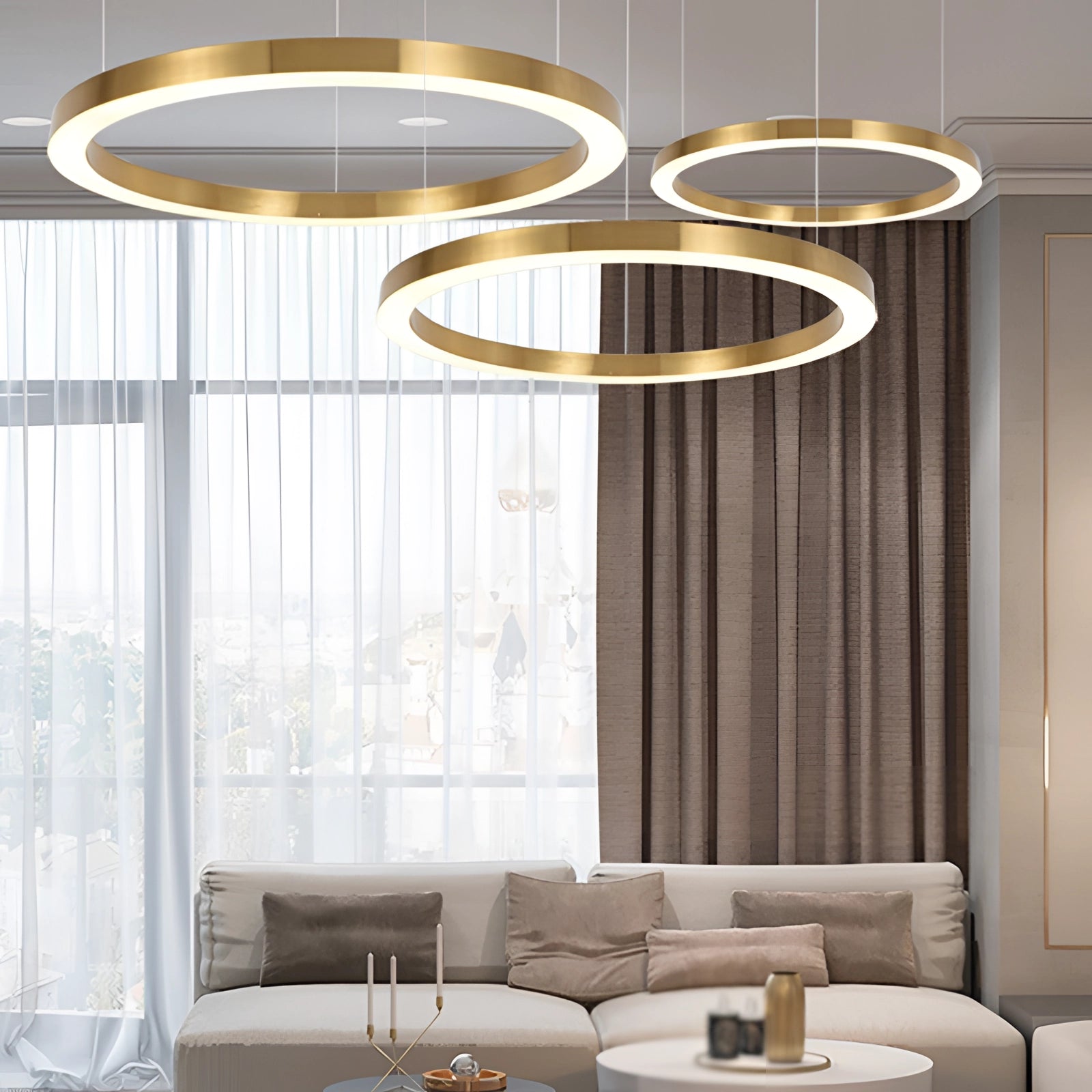 Gold circular LED chandelier with a modern minimalist design, hanging above a living space with furniture including a couch and a table, complemented by interior design elements like wood accents and decoration, casting a warm yellow light.