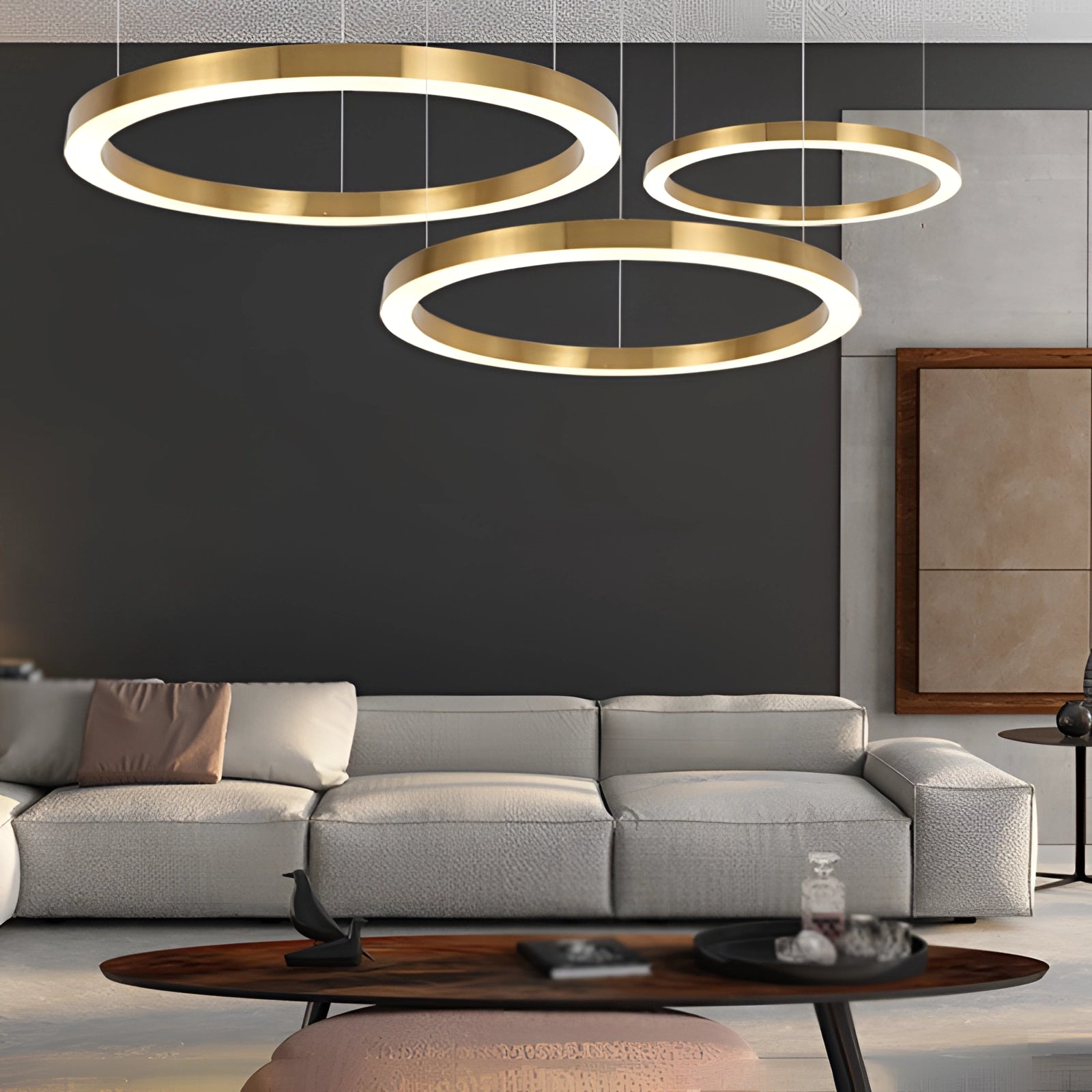 Gold Circular LED Chandelier in a modern minimalist design, illuminated in an interior setting, casting a soft white light over a contemporary living space with a black couch.