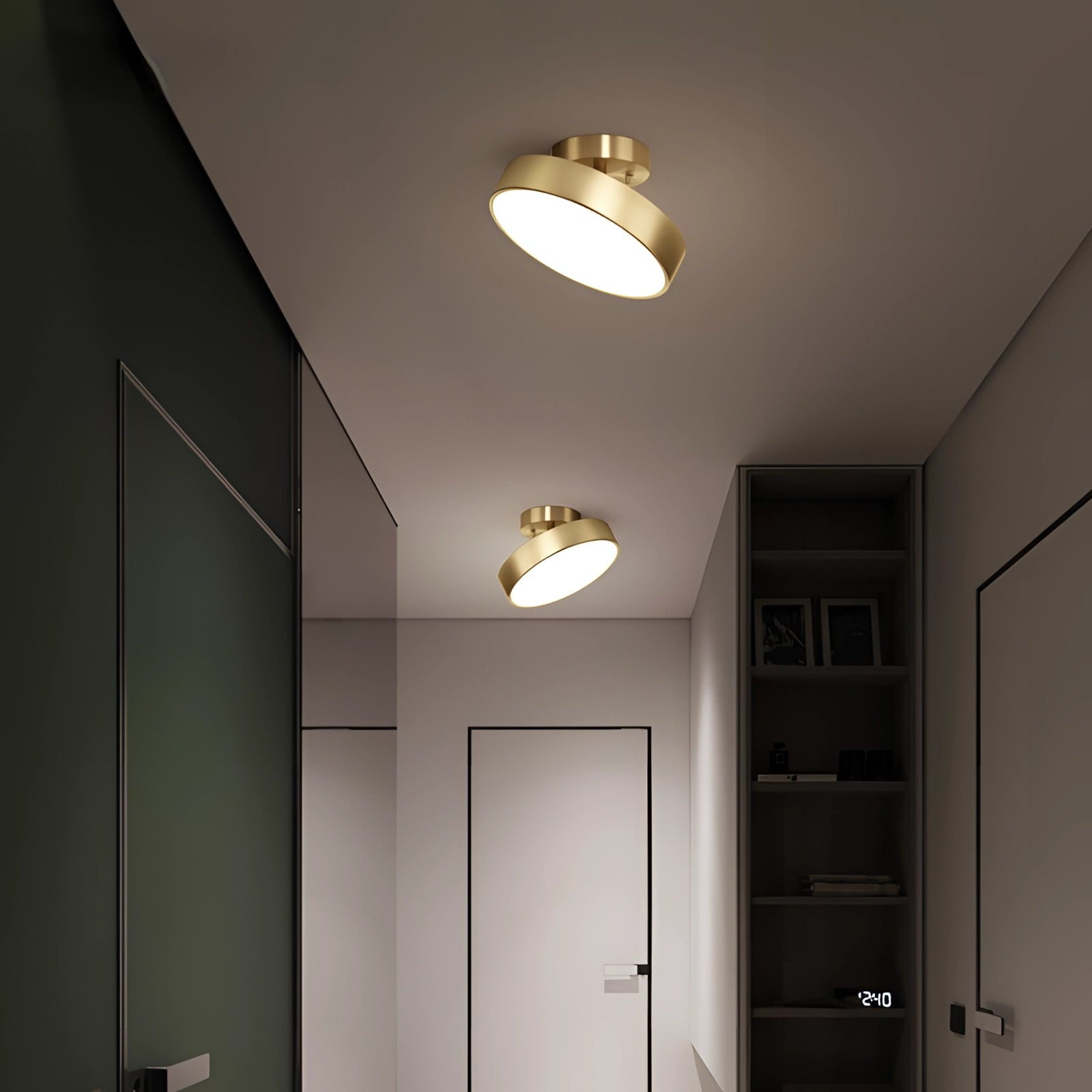 Modern minimalist circular gold LED flush mount ceiling light fixture installed in a contemporary interior space with wooden cabinetry and architectural elements.