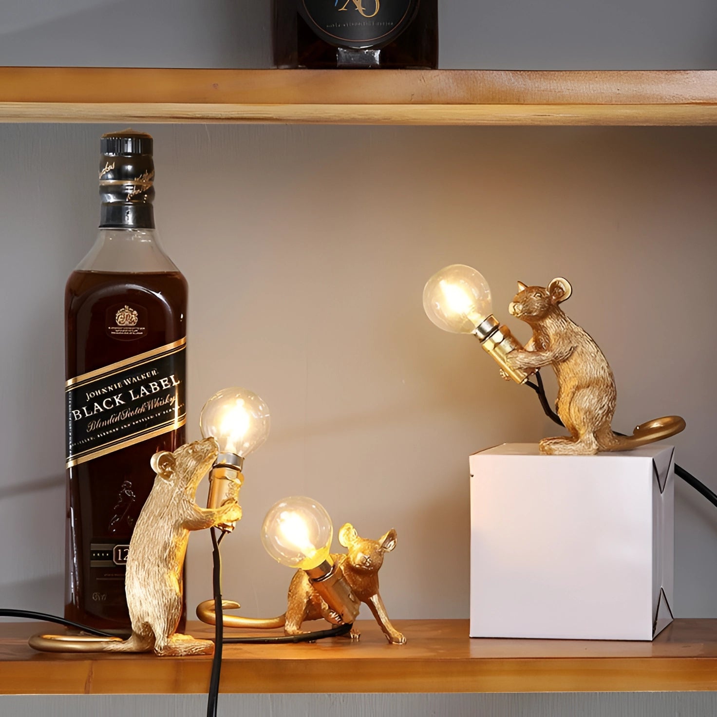 A whimsical gold mouse-shaped lamp with a light fixture integrated into its design, perfect as an eccentric piece of decor for desks or shelves.
