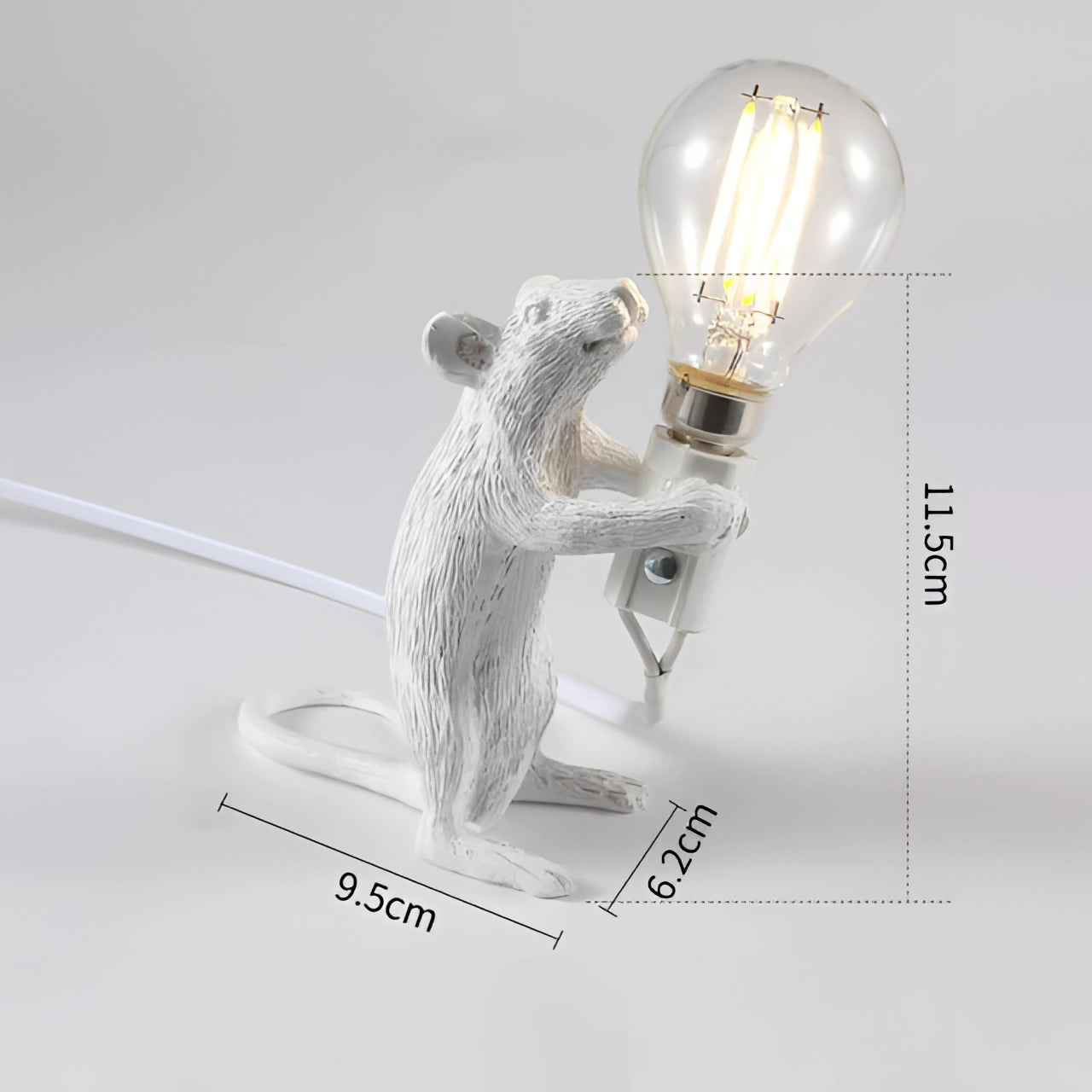 A quirky, gold mouse-shaped lamp standing upright, with a light bulb held in its paws. The lamp has a metallic finish and serves as an eccentric decorative piece for desks.