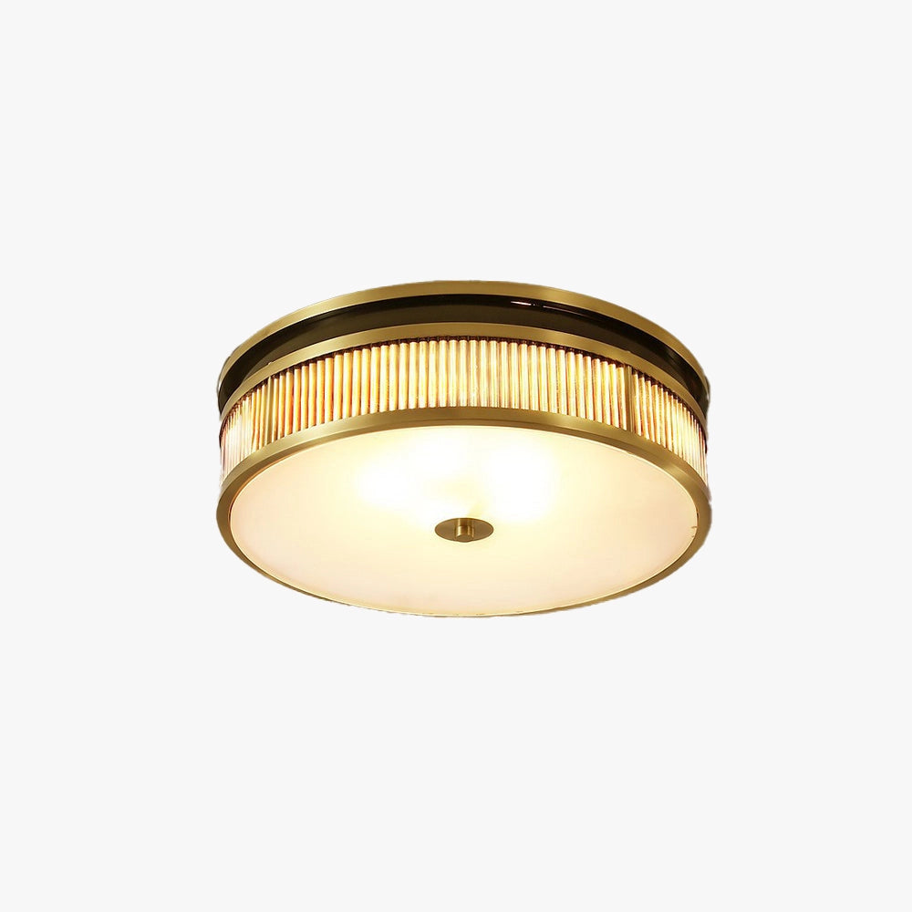 Gold-trimmed circular flush mount ceiling light with a decorative design, featuring an amber-colored finish and a sophisticated metal frame, elegantly illuminating the ceiling.